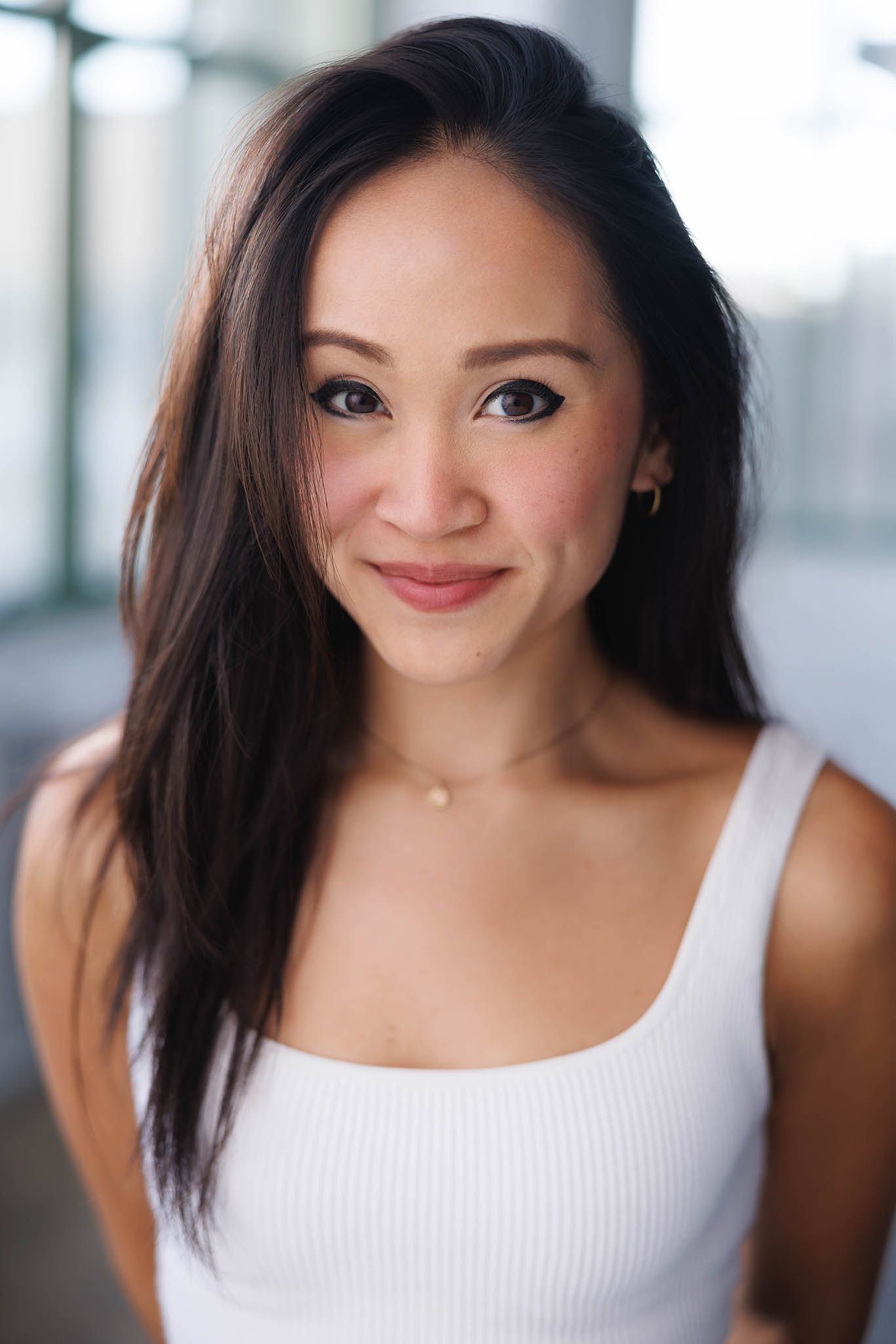 A series of five headshots showing someone in a white tank top with dark hair against a light background.