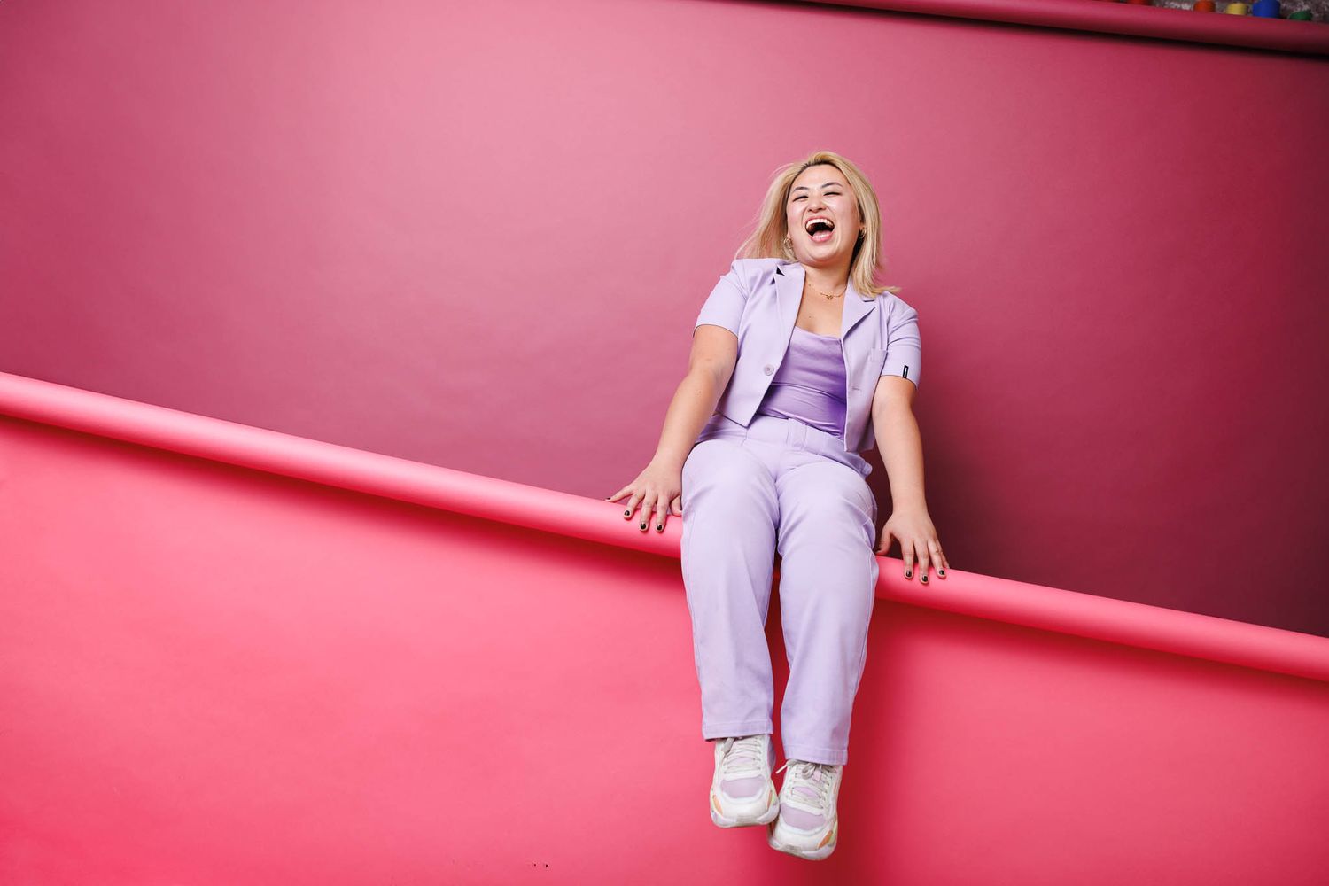 Pink-toned portrait series showing dynamic poses against vibrant background.
