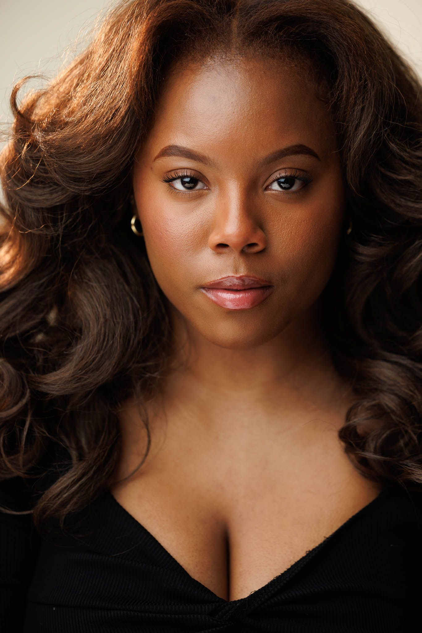 Professional beauty portrait series with dramatic lighting against dark background.