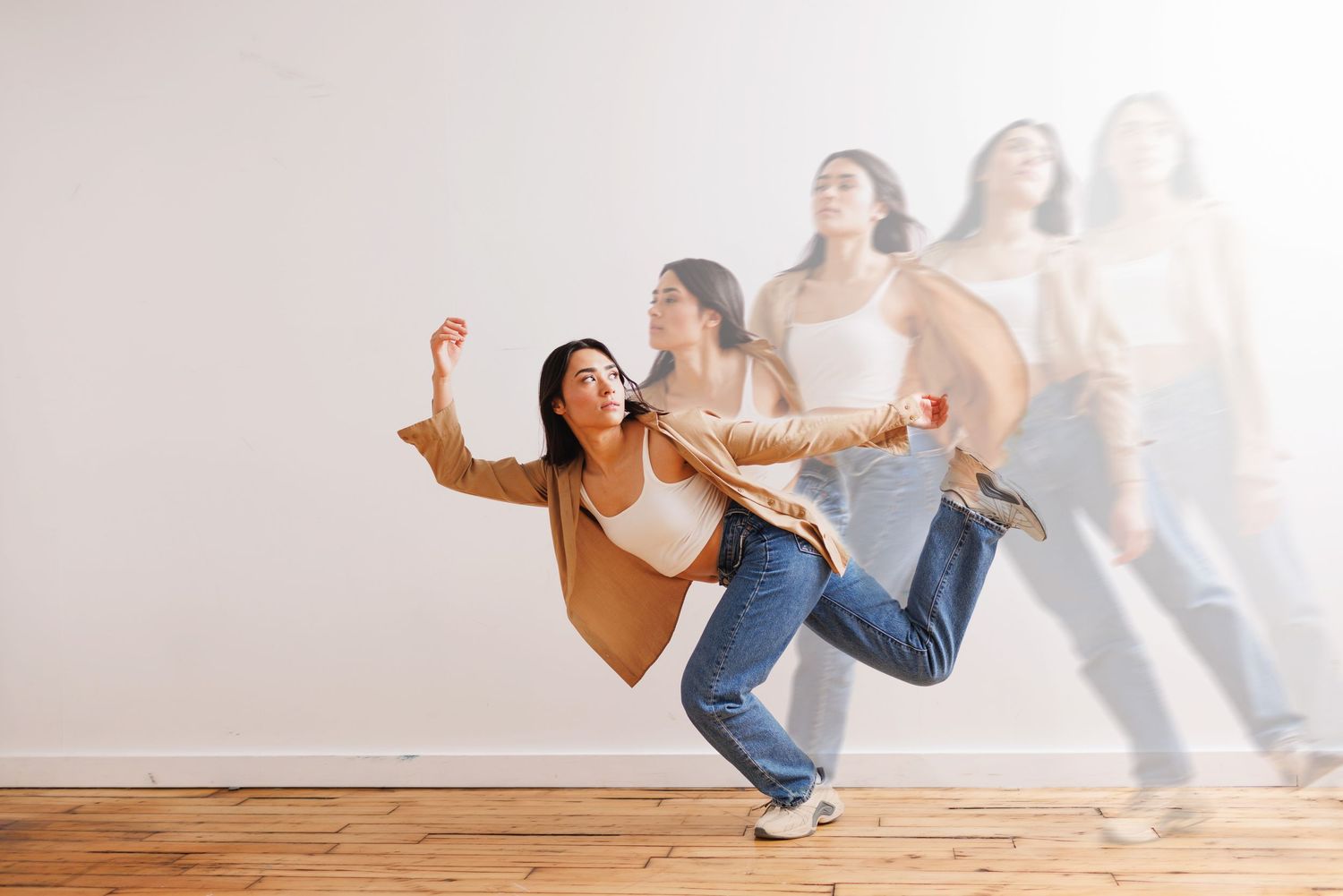 Dynamic dance sequence against a white studio background.