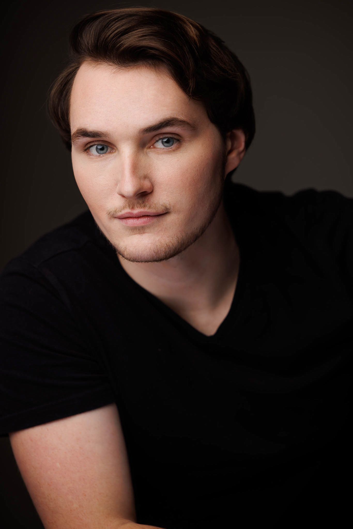 A series of dramatic studio portrait headshots on a dark background showing different profile angles.