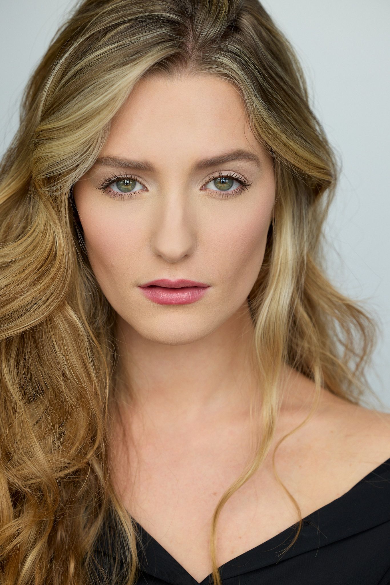Professional headshot series showing different angles of a blonde model wearing a black top against a light background.