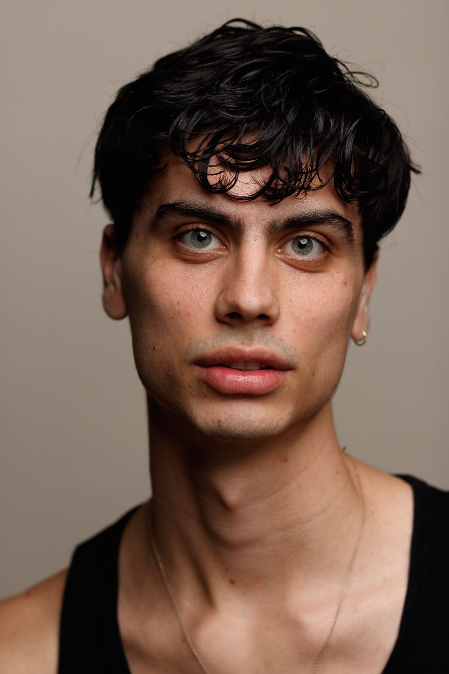 Close-up portrait in studio lighting against neutral background.