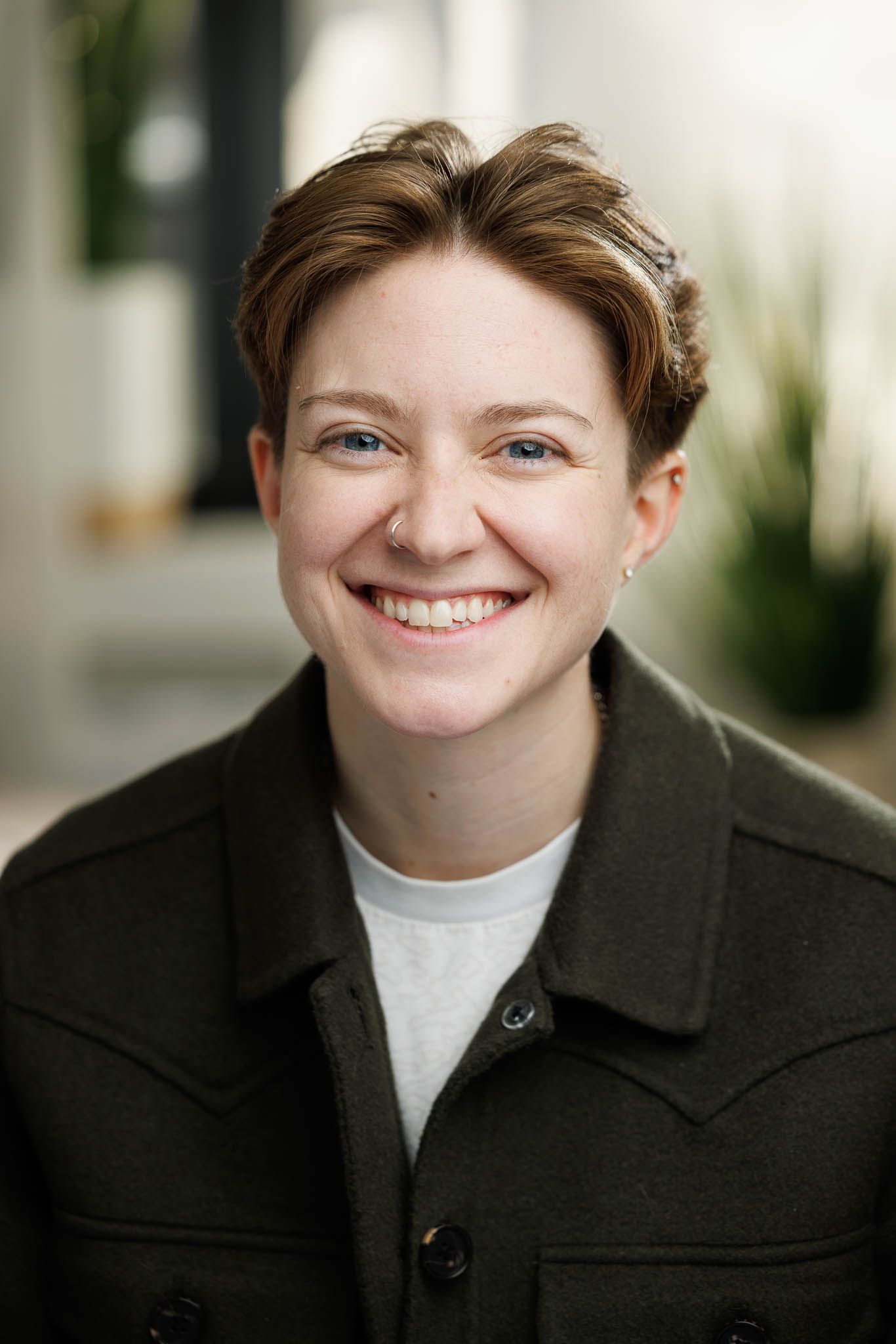 Professional headshot series in business attire with natural lighting.