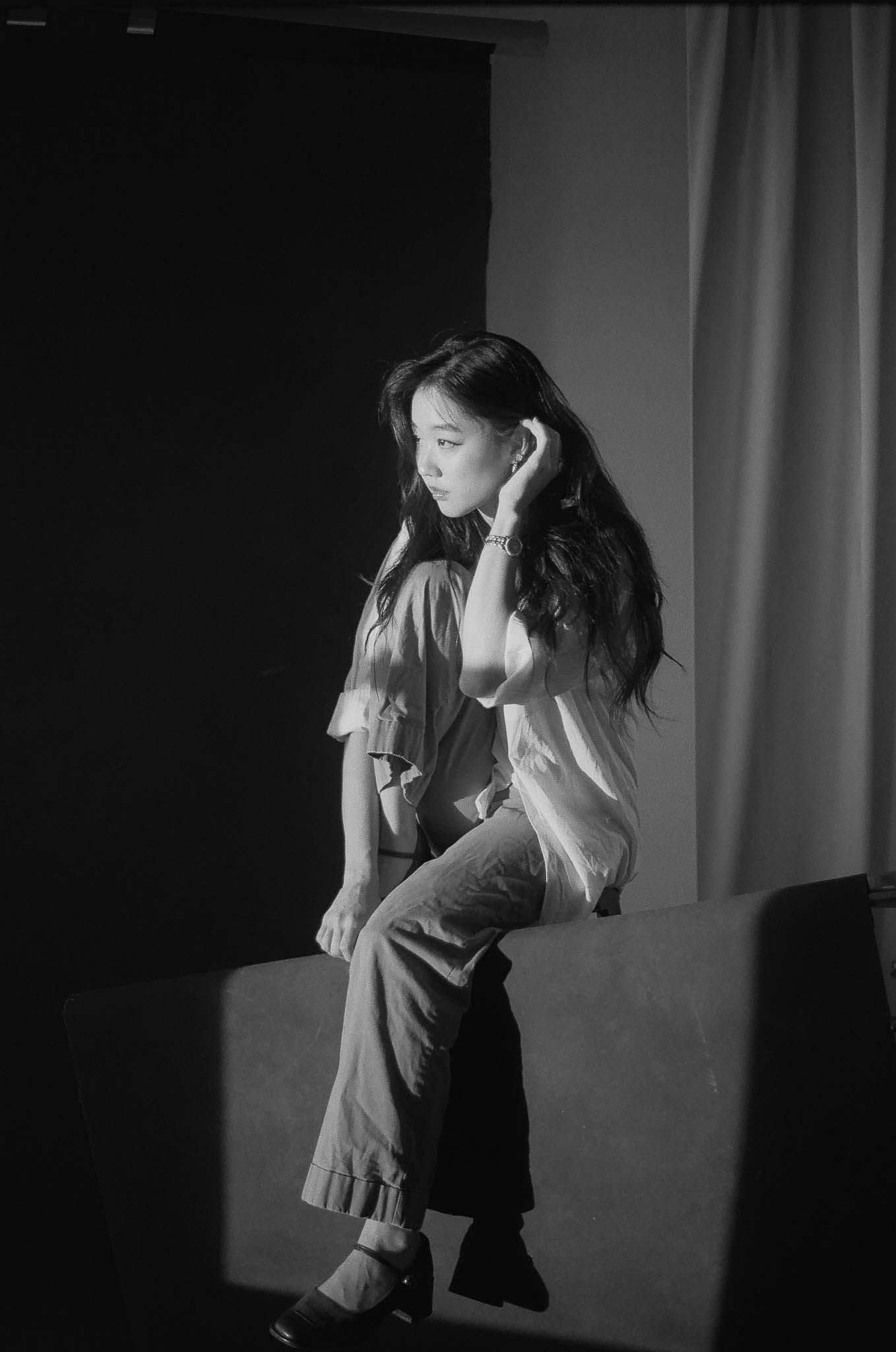 A dramatic black and white photo series showing a figure in motion against a dark background.