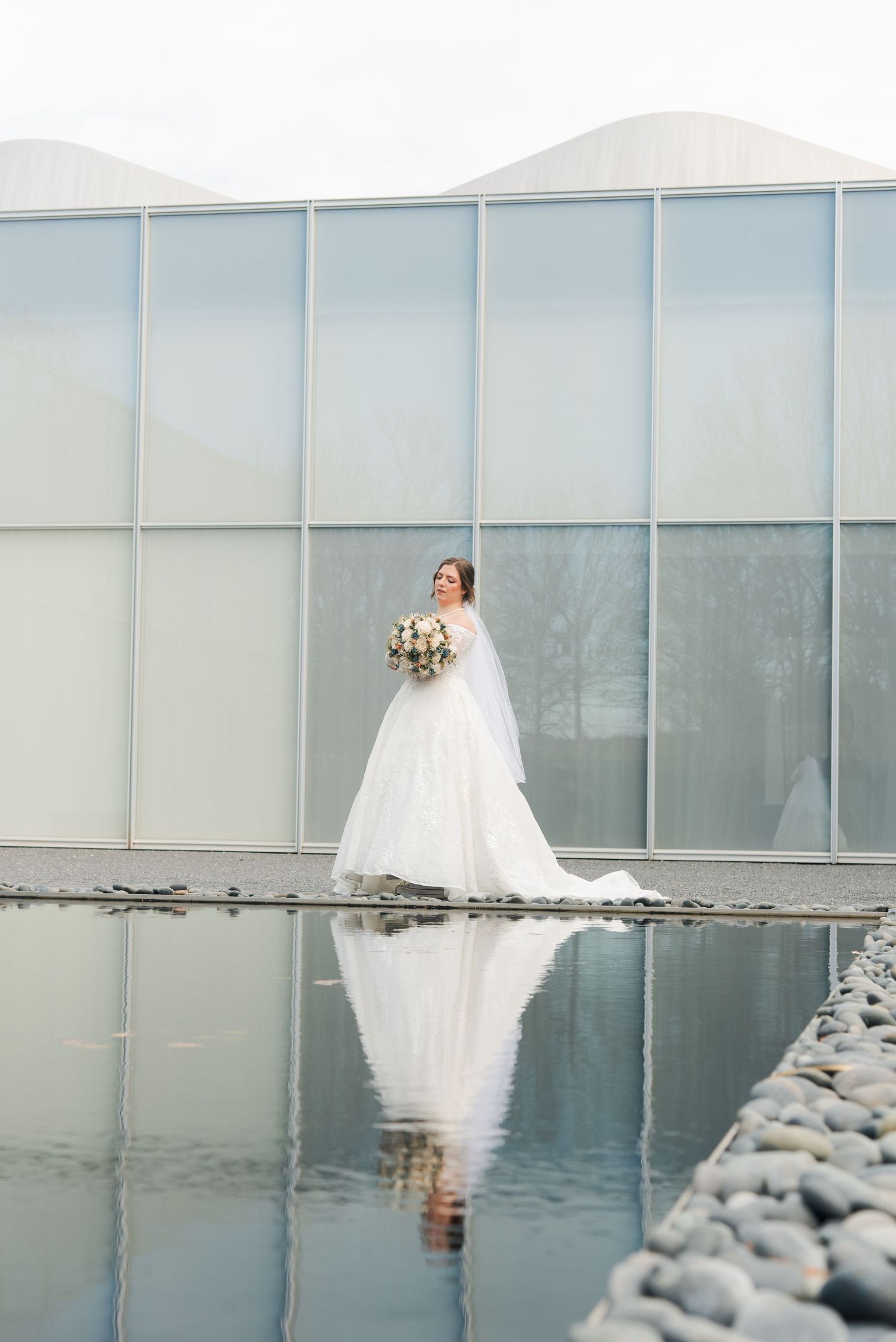 Bridal portraits at the NC Museum of art in Raleigh, NC. Dramatic bridal portraits. Reflecting water photoshoot.