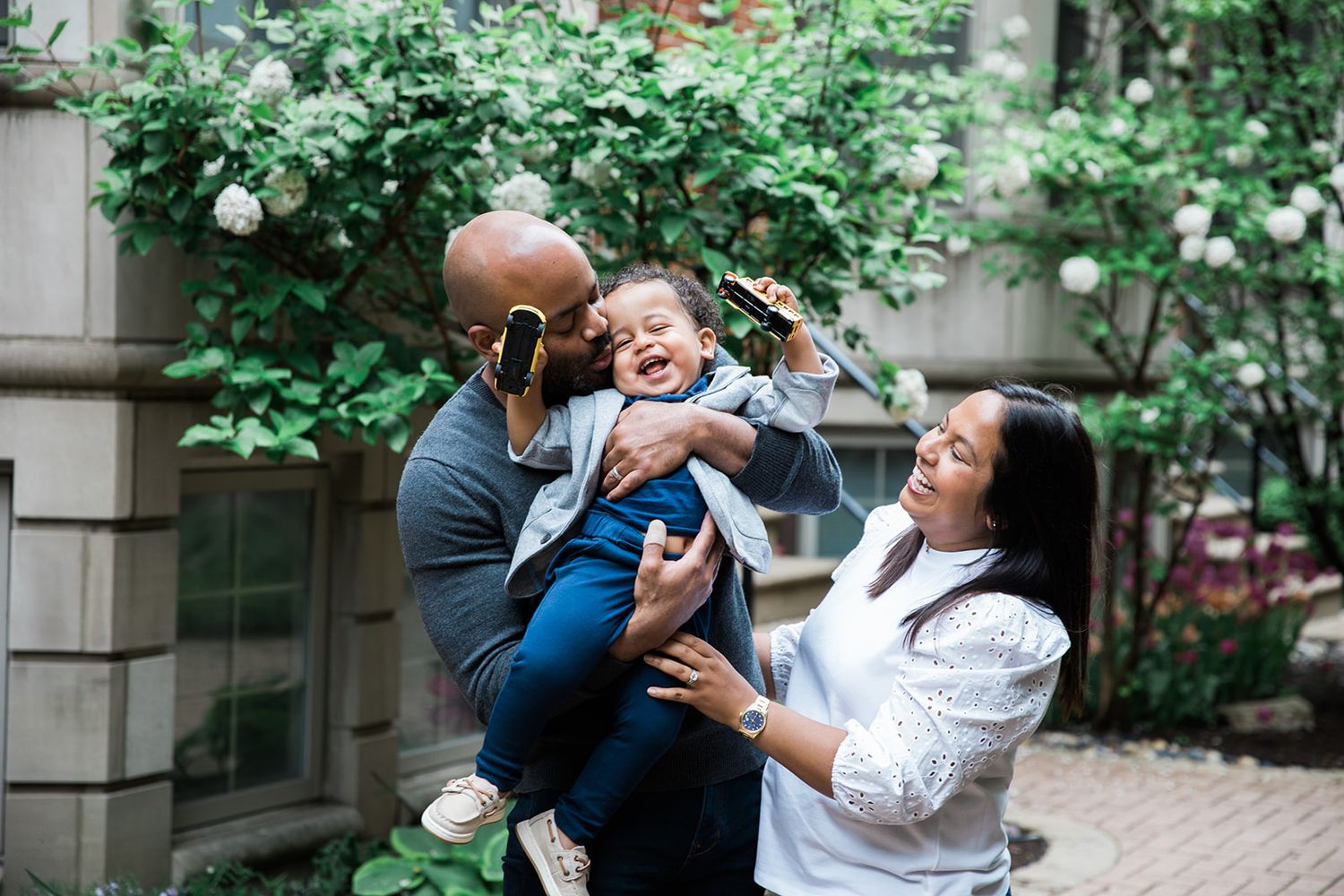 Chicago family photographers, young family in courtyard at home photoshoot