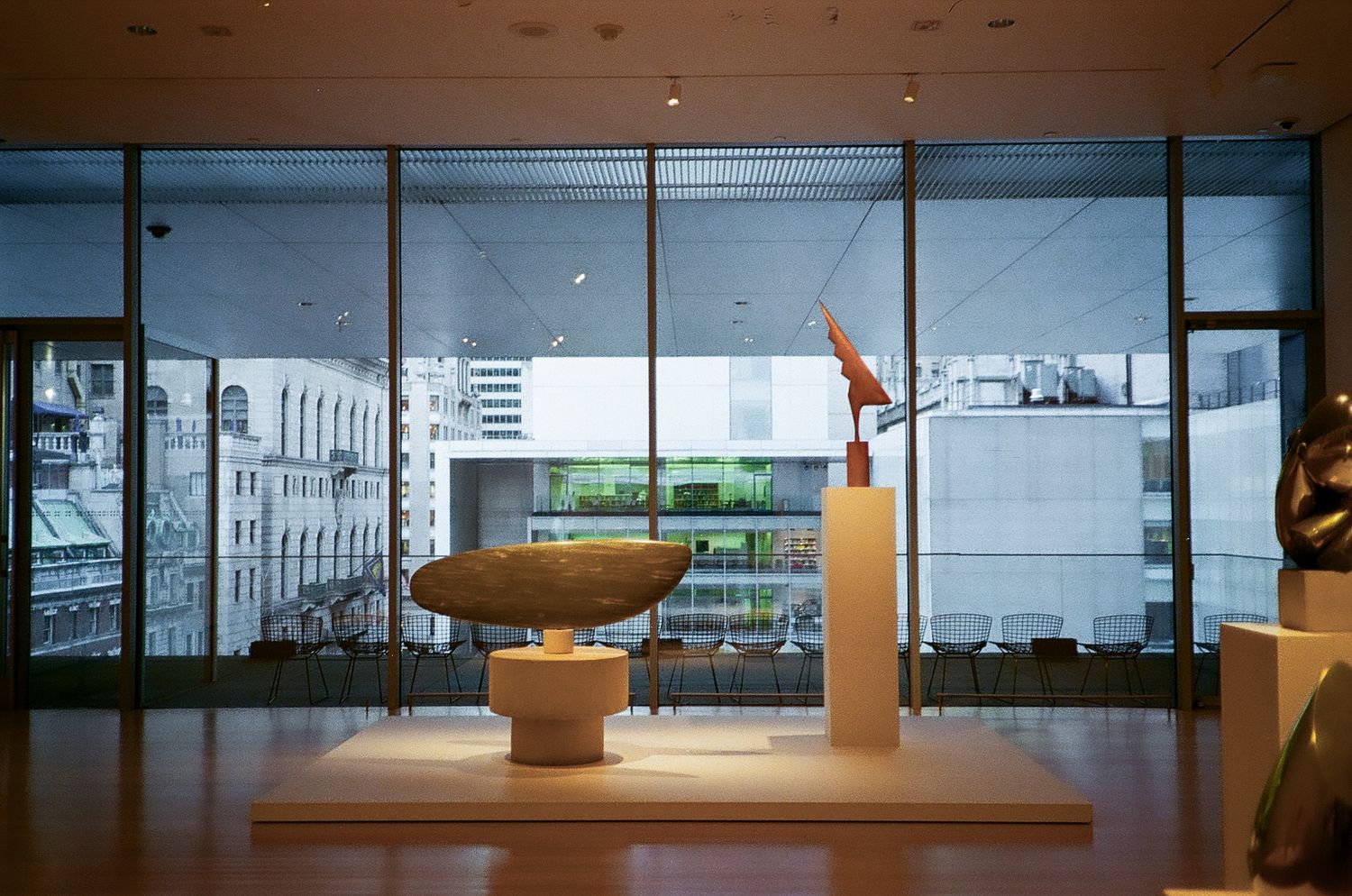 Modern art sculpture displayed in a minimalist gallery space with floor-to-ceiling windows in the Metropolitan Museum of Art in New York.