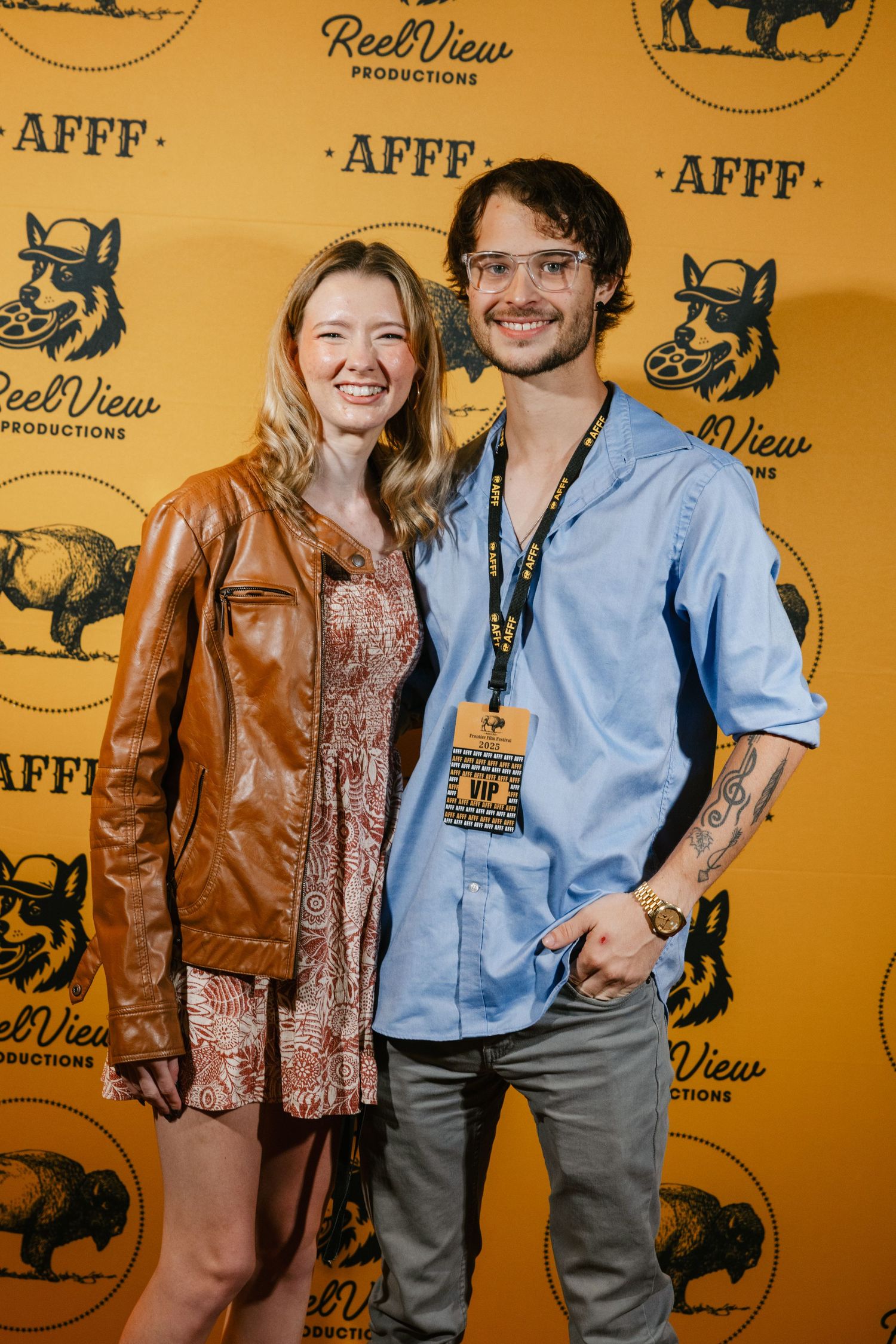 Group poses against a yellow backdrop with ReelView and AFFF logos at what appears to be a film event.