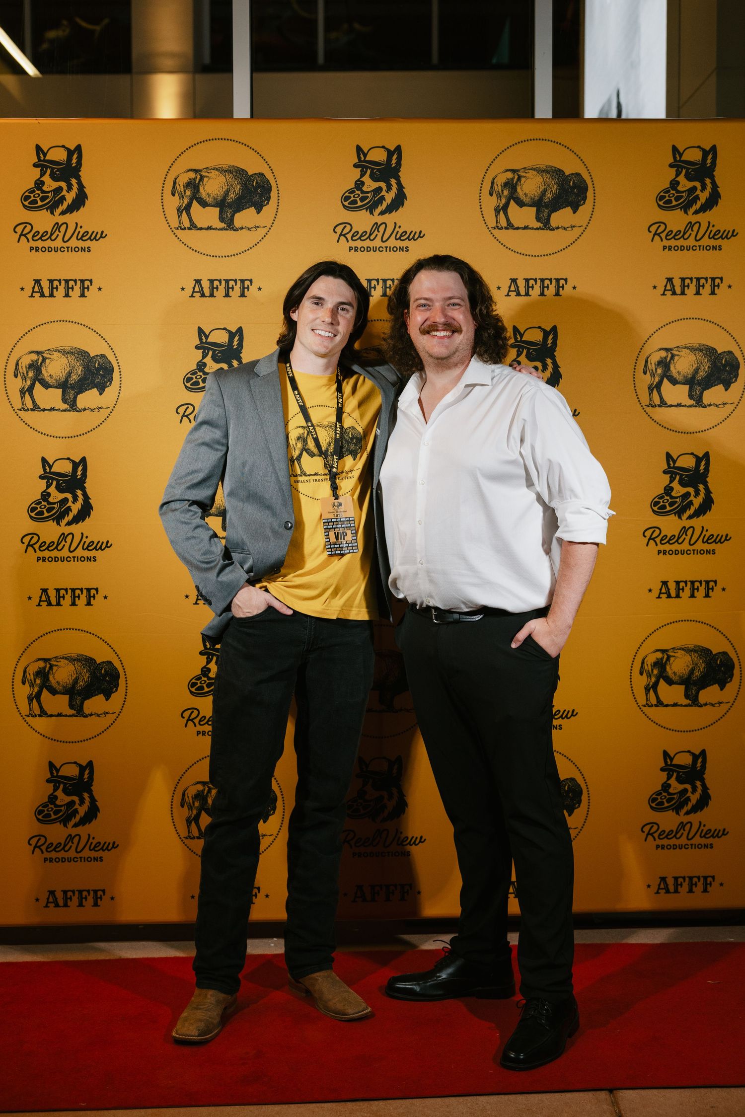 A series of four similar red carpet photos showing people posing against a yellow backdrop with animal logos.