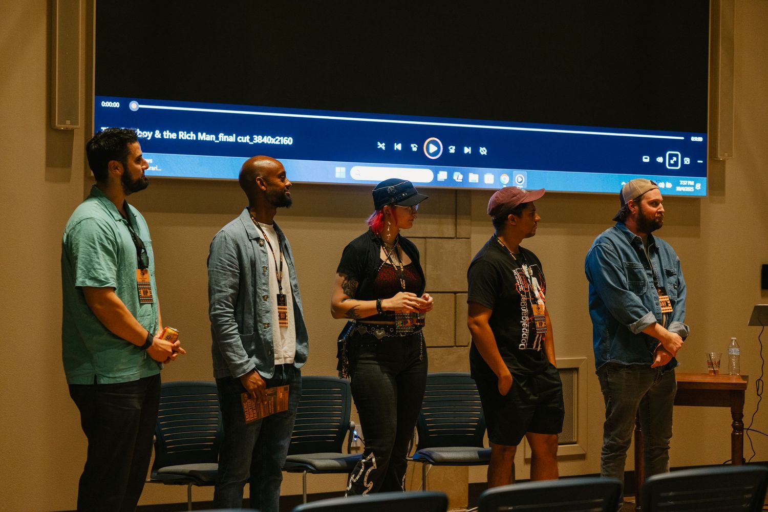 Conference attendees stand in line at a tech event while waiting to check in at registration tables.