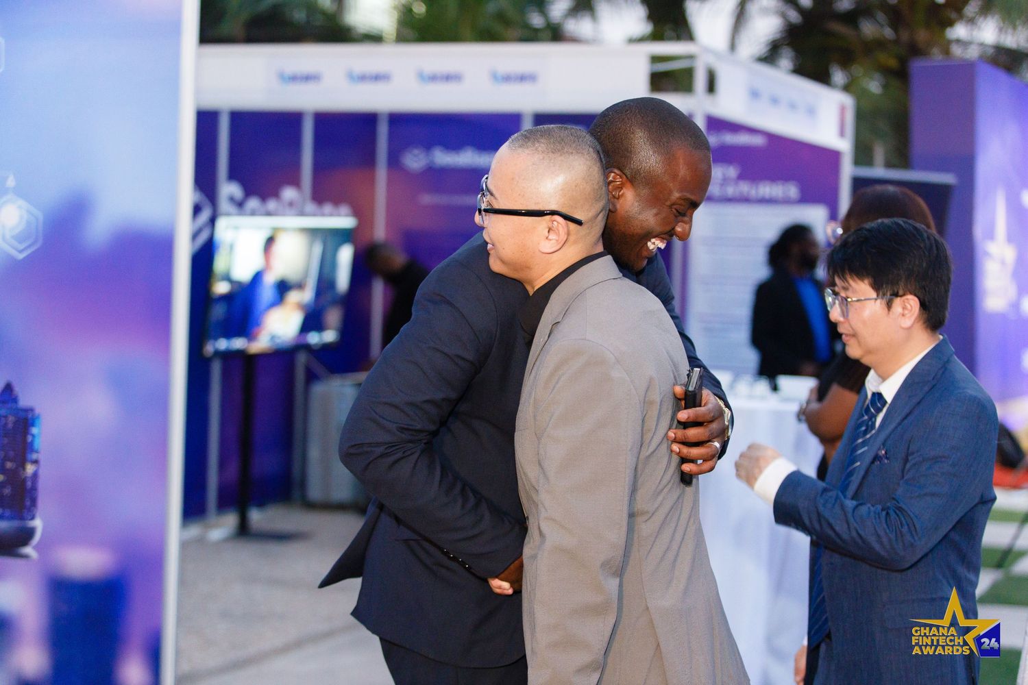 Candid moment from a corporate event in Accra photographed by The BLUEshutter.