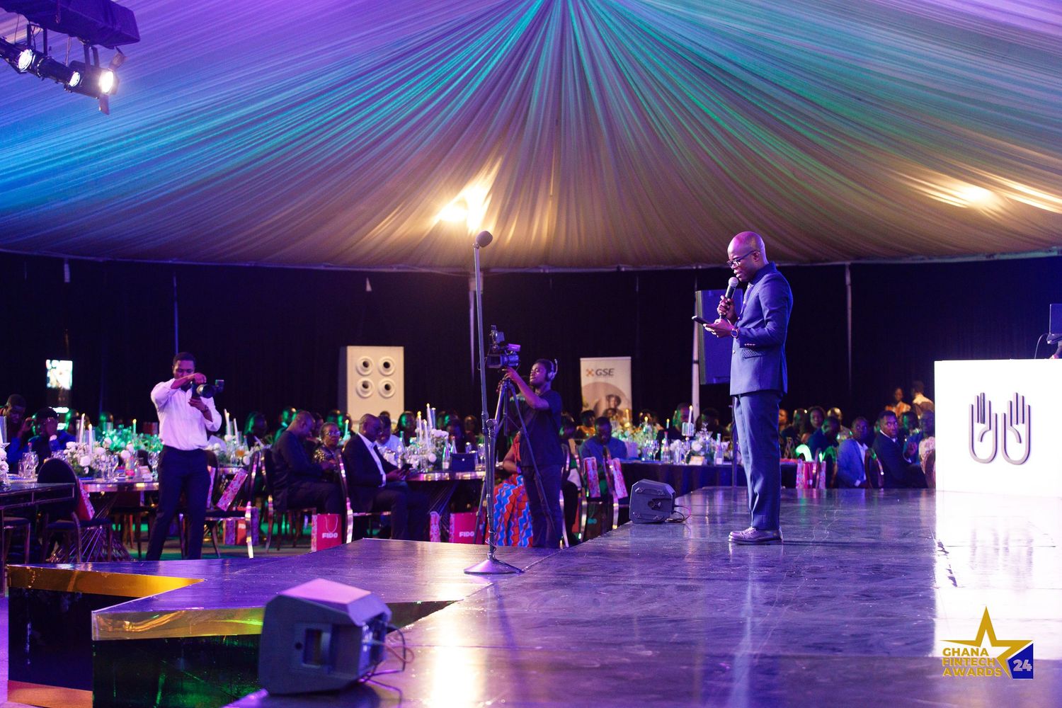 Candid moment from a corporate event in Accra photographed by The BLUEshutter.
