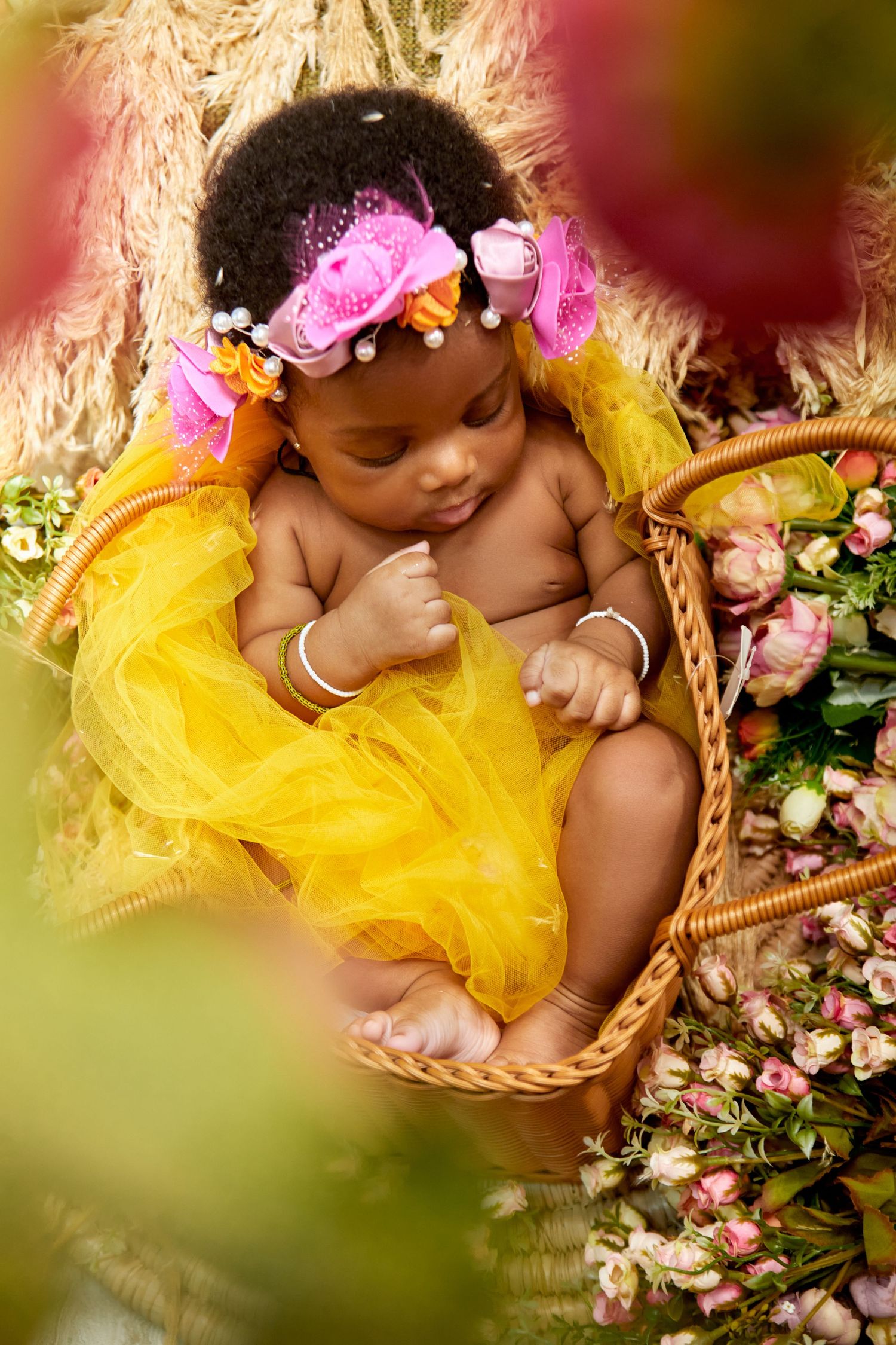 Baby Portrait with yellow flowers with warm tones
