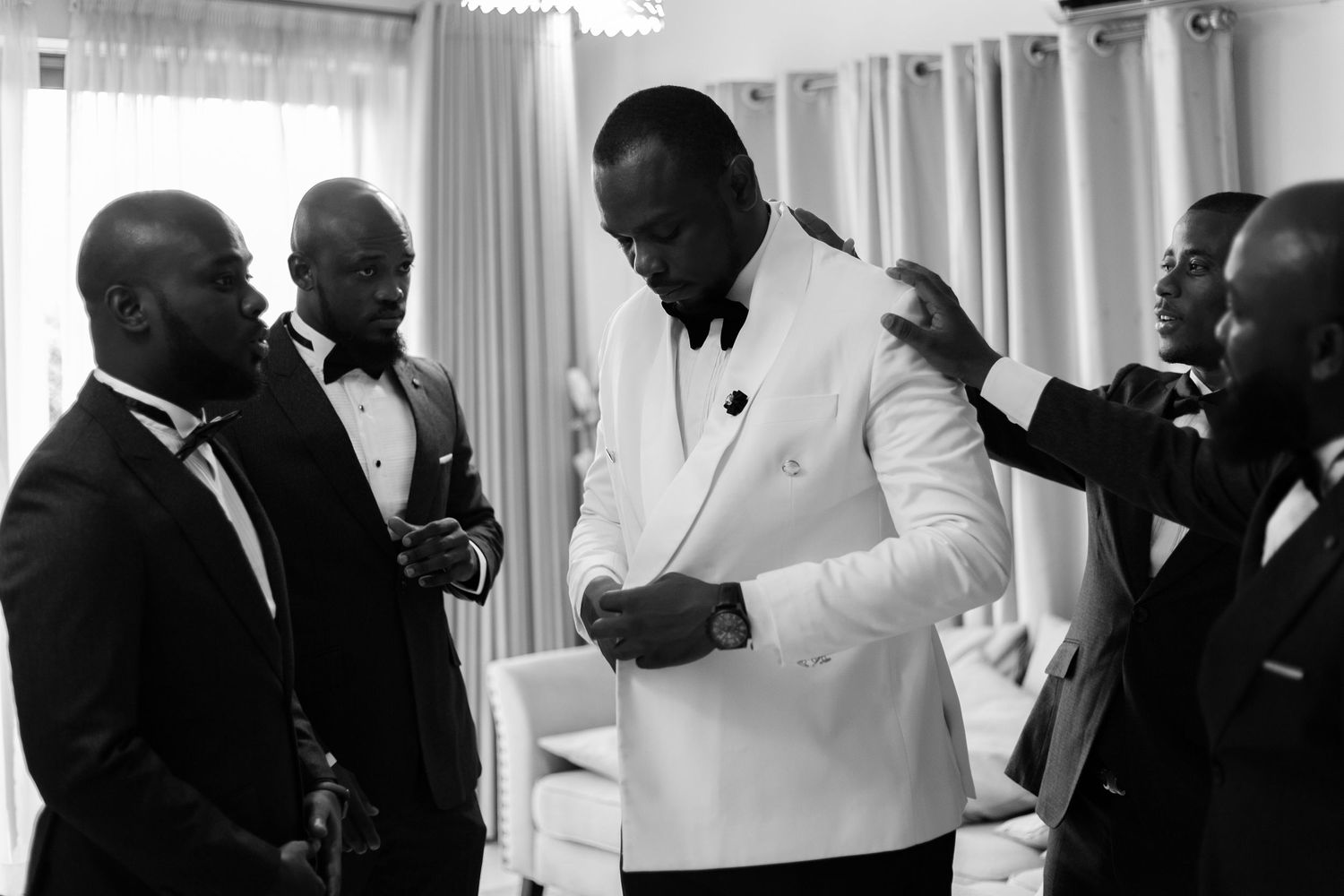 Groom and groomsman at a white wedding
