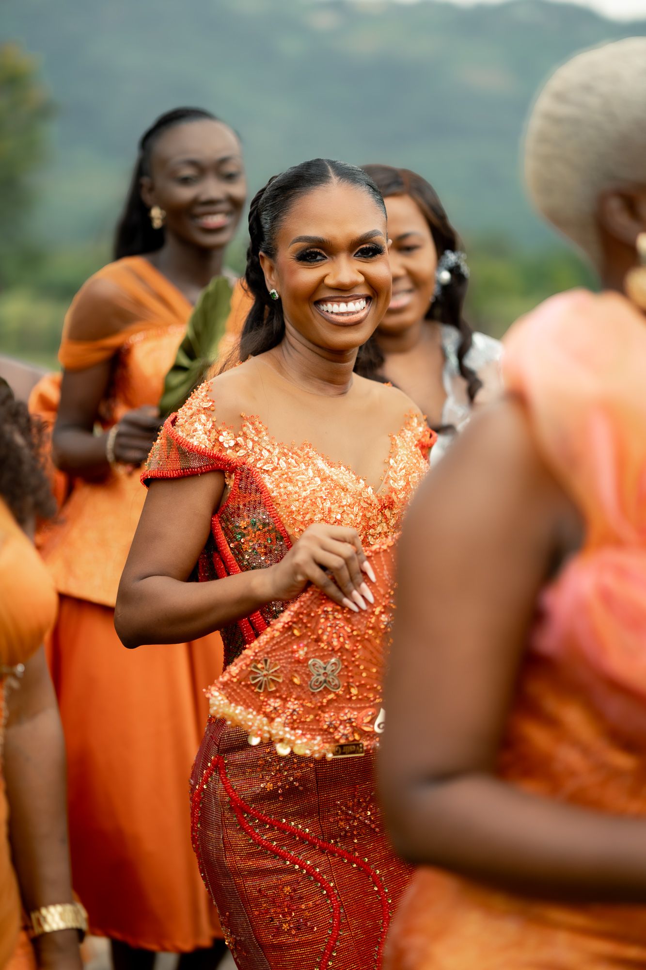 Ghanaian bride dancing in vibrant Kente attire