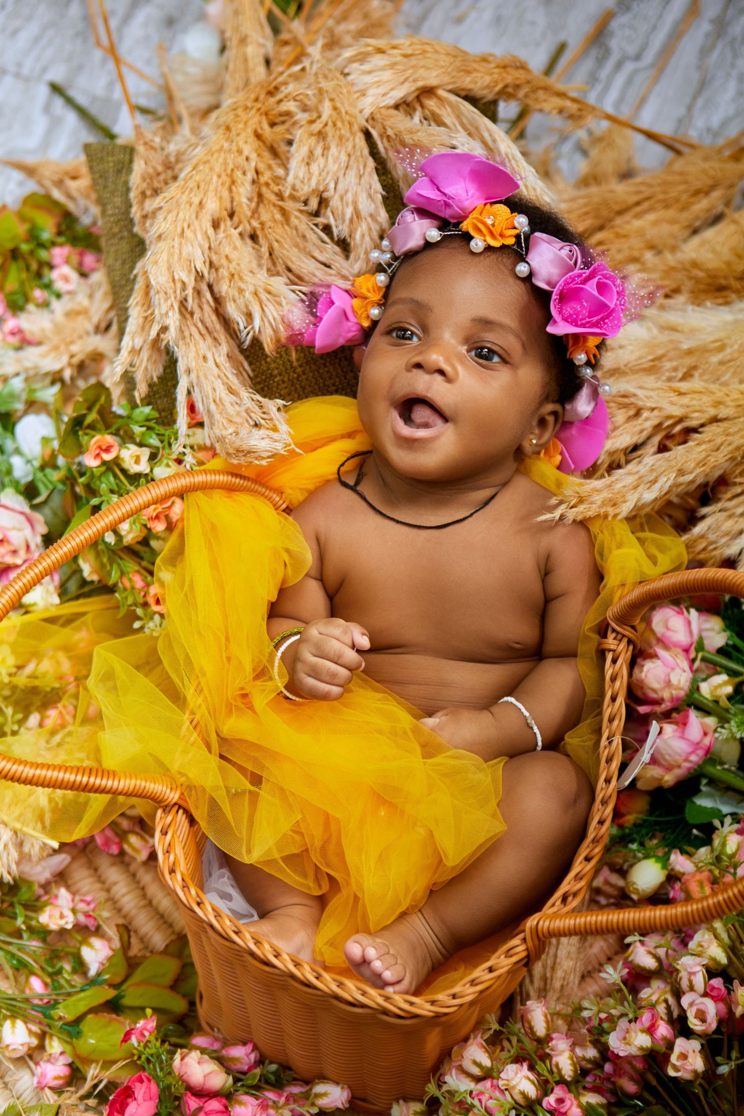 Baby Portrait with yellow flowers with warm tones