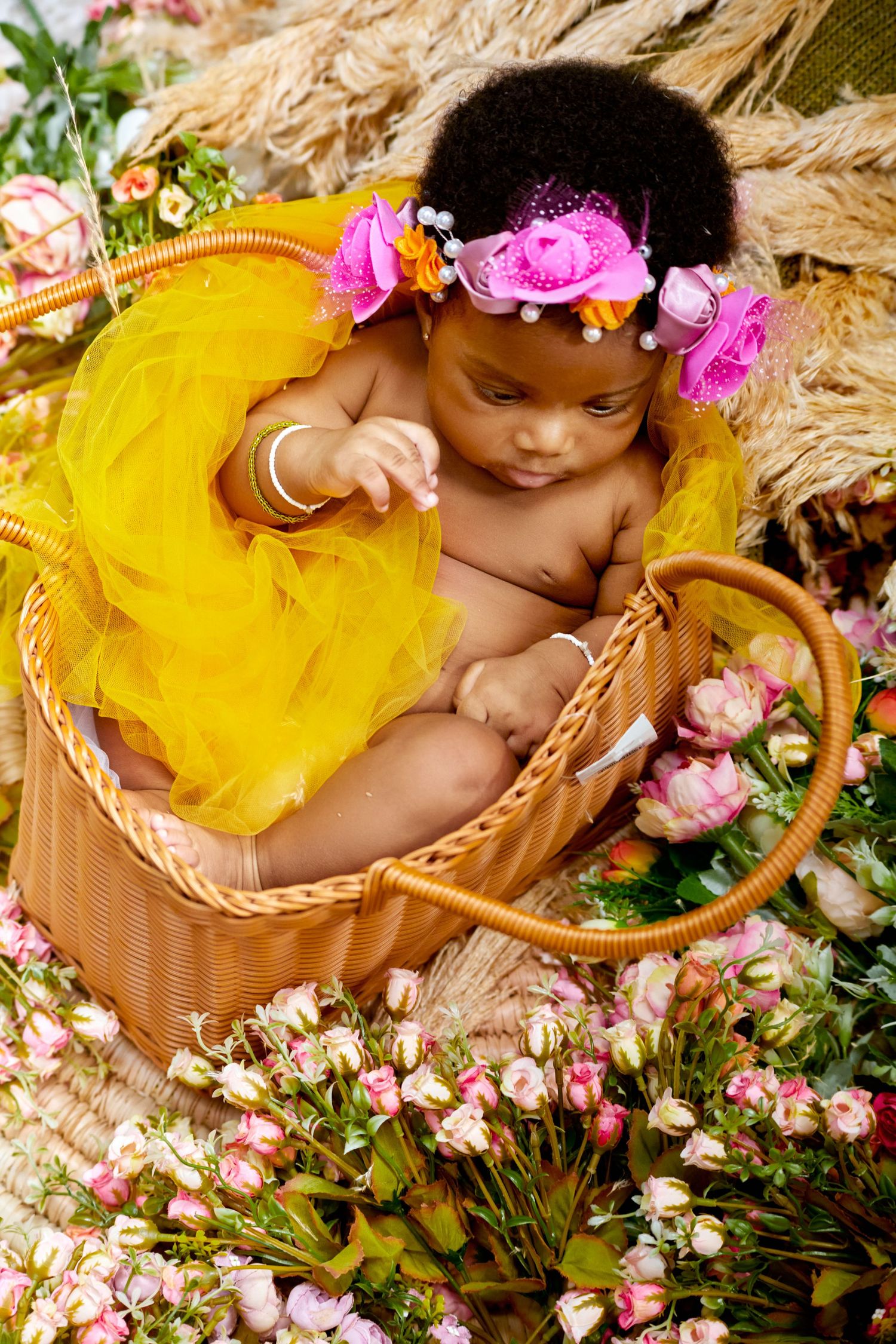 Baby Portrait with yellow flowers with warm tones
