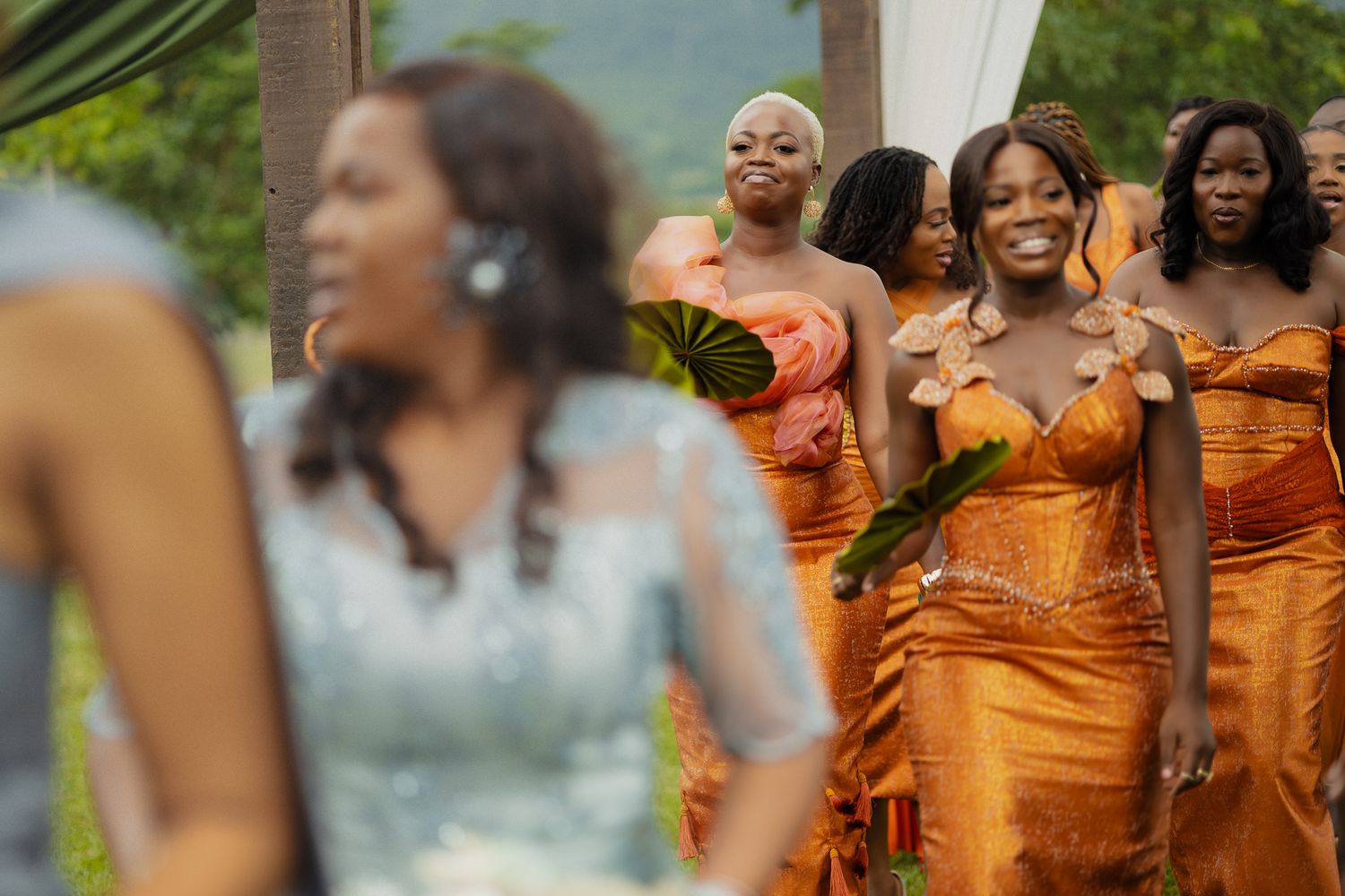 Ghanaian bride dancing in vibrant Kente attire