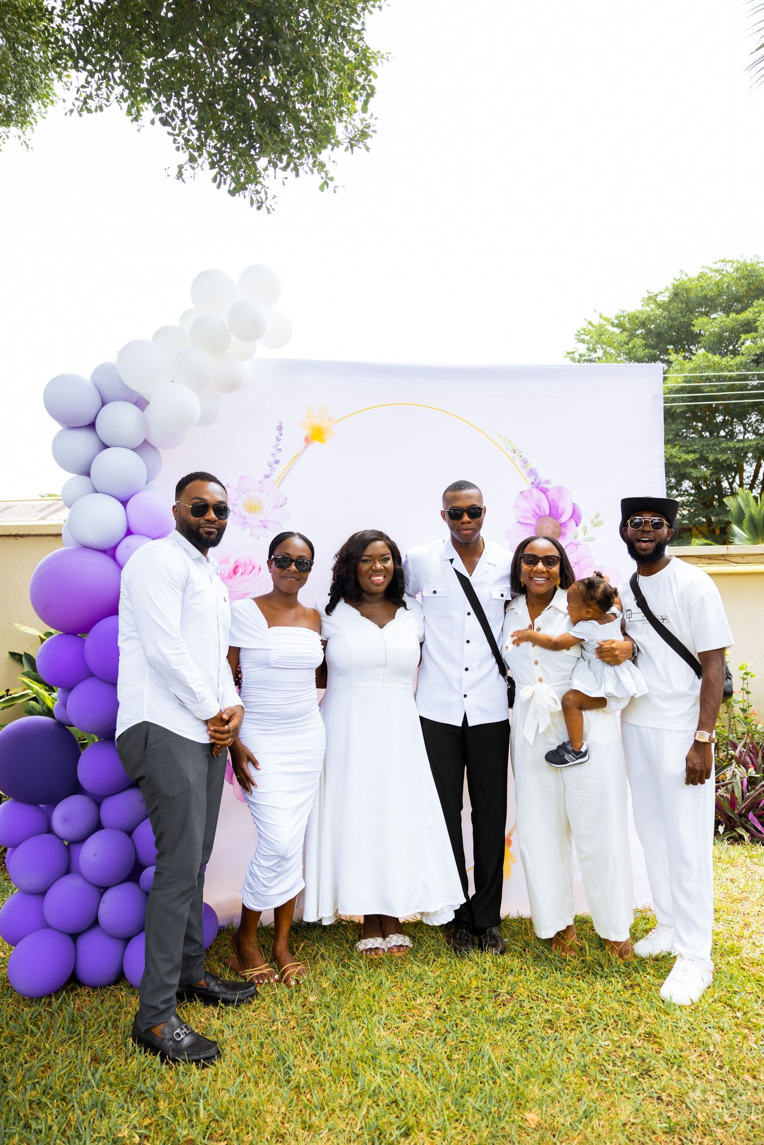 Baby surrounded by family at naming celebration reception