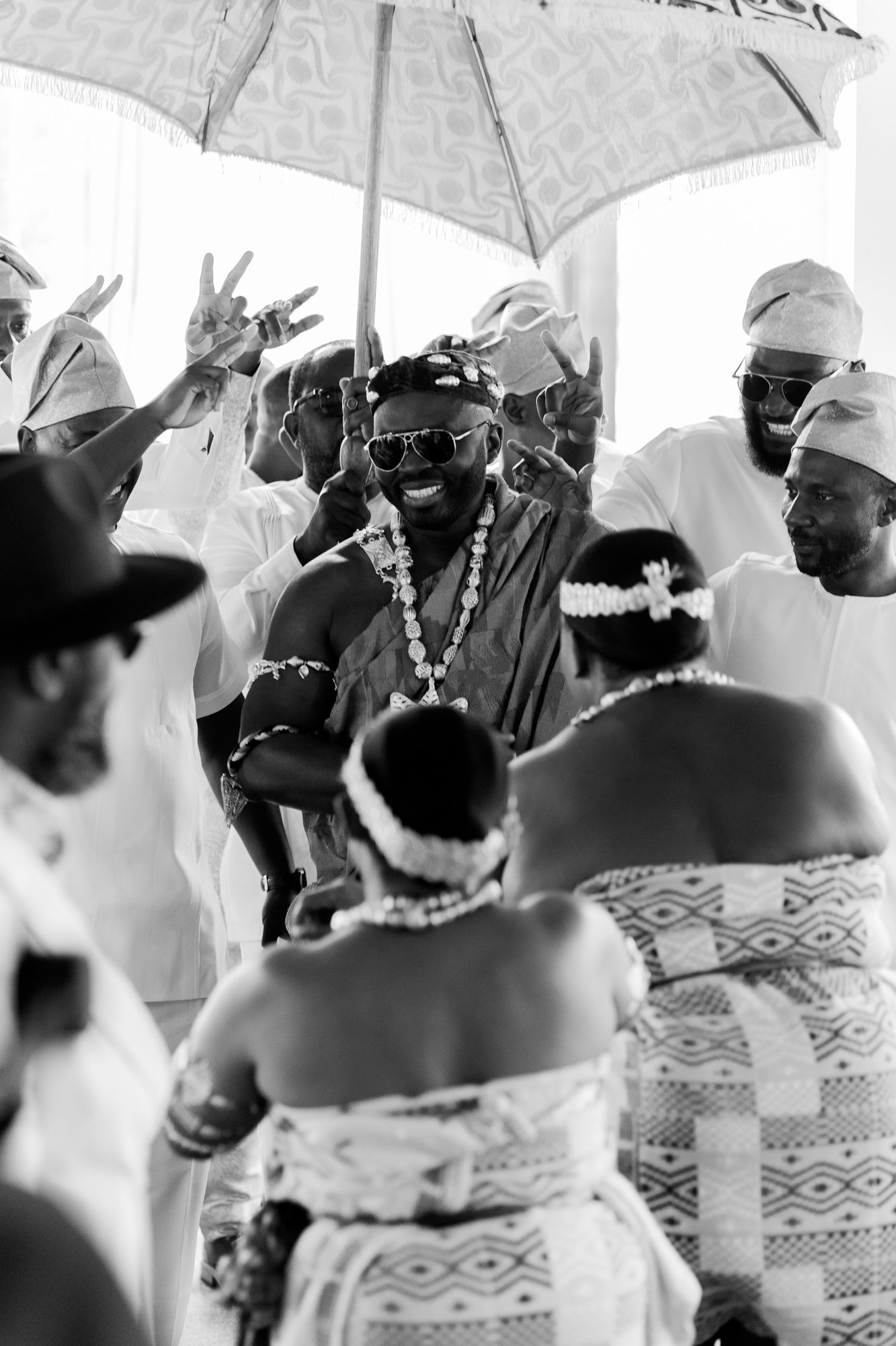 Groom making his entrance at wedding ceremony in Accra win kente