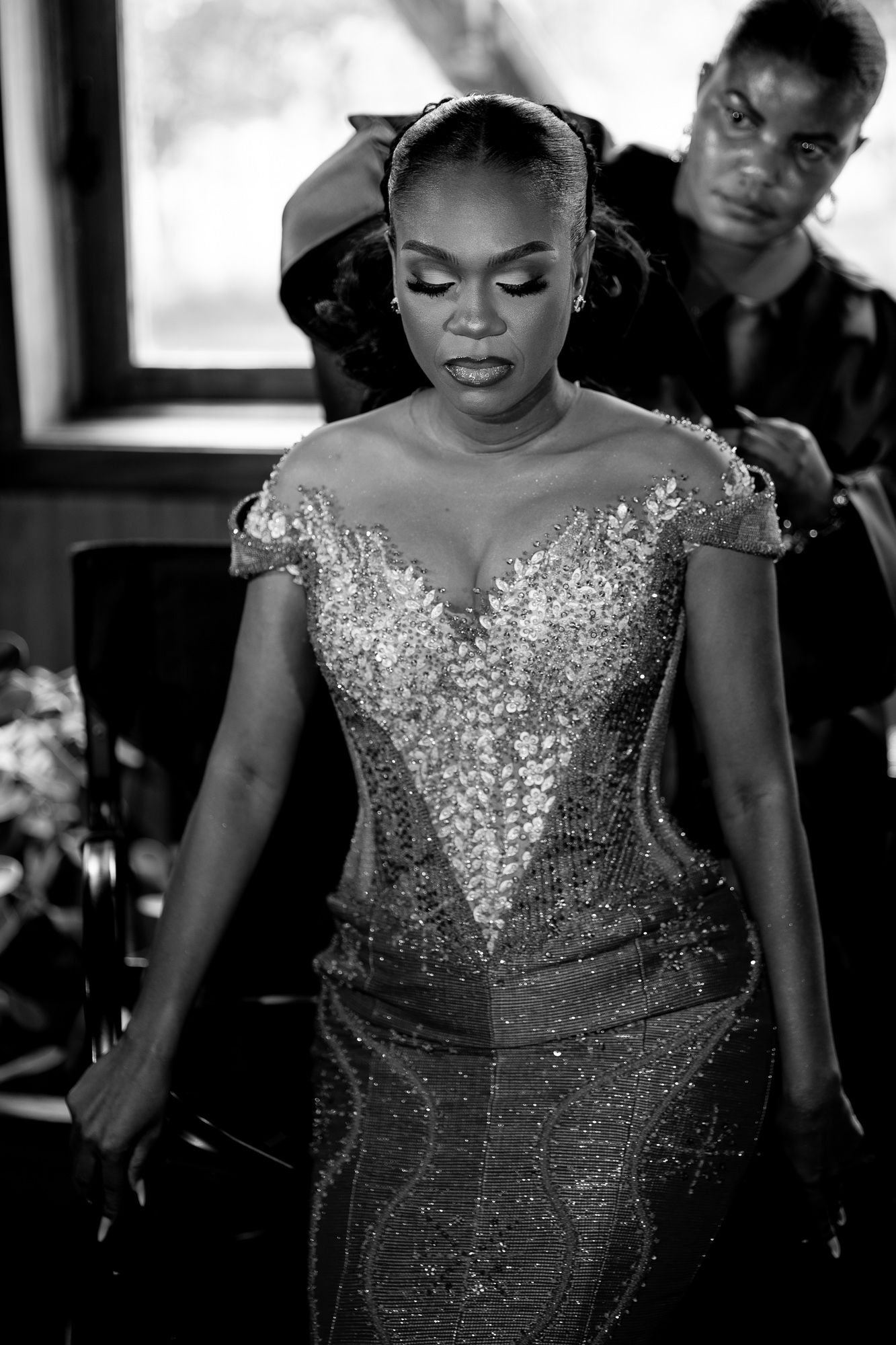 Bride getting dressed in kente before her wedding ceremony in Ghana,