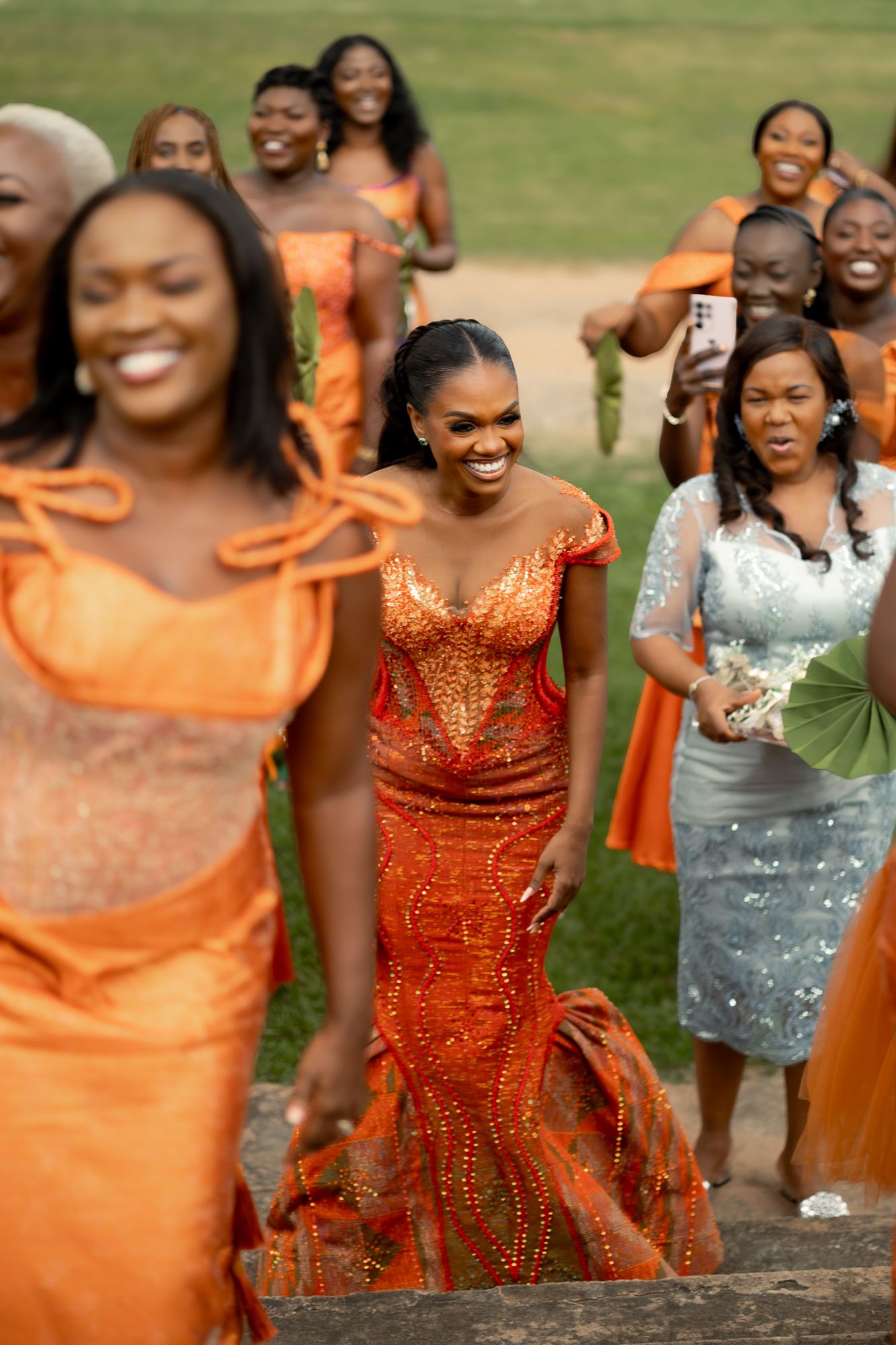 Ghanaian bride dancing in vibrant Kente attire