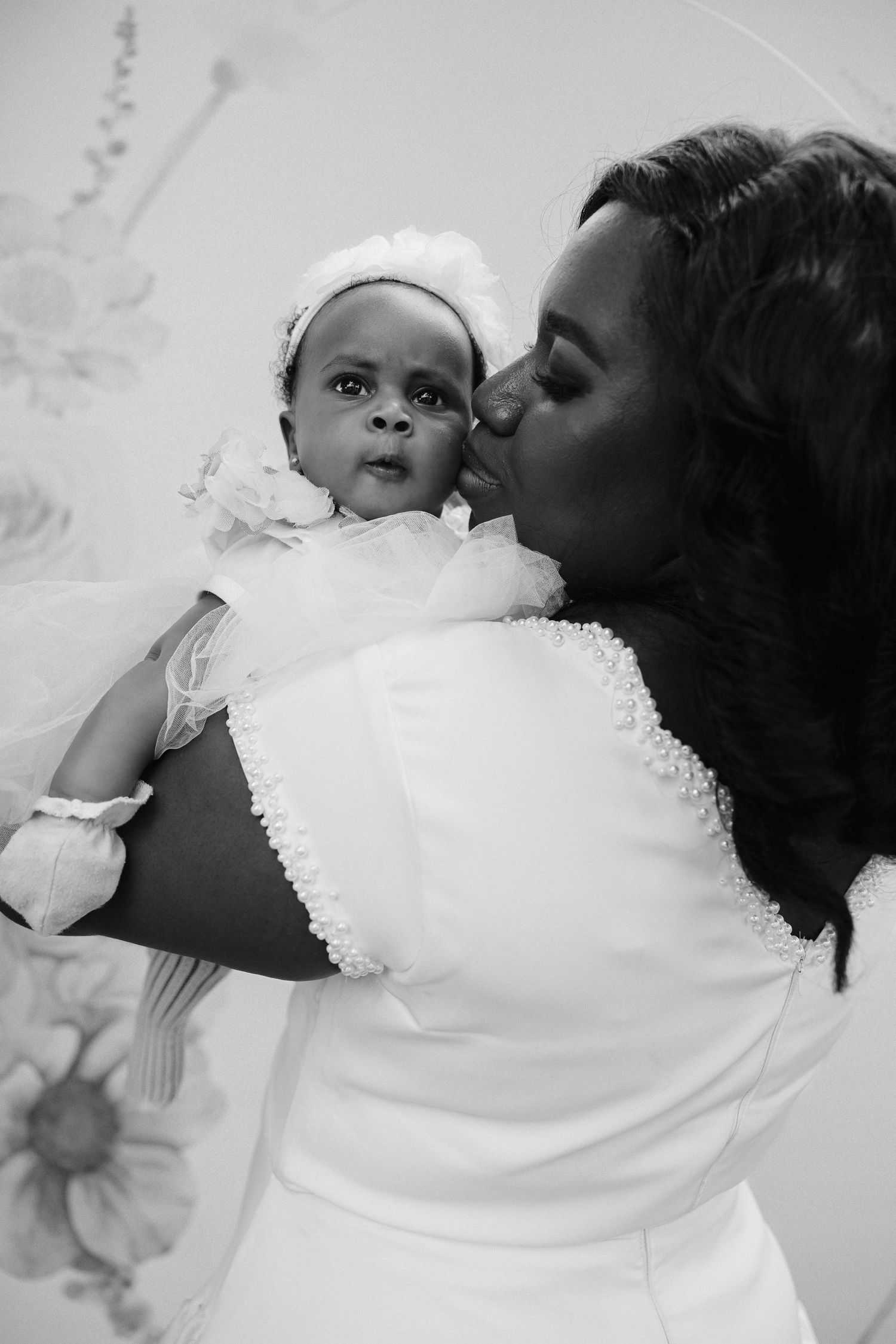 Baby surrounded by family at naming celebration reception