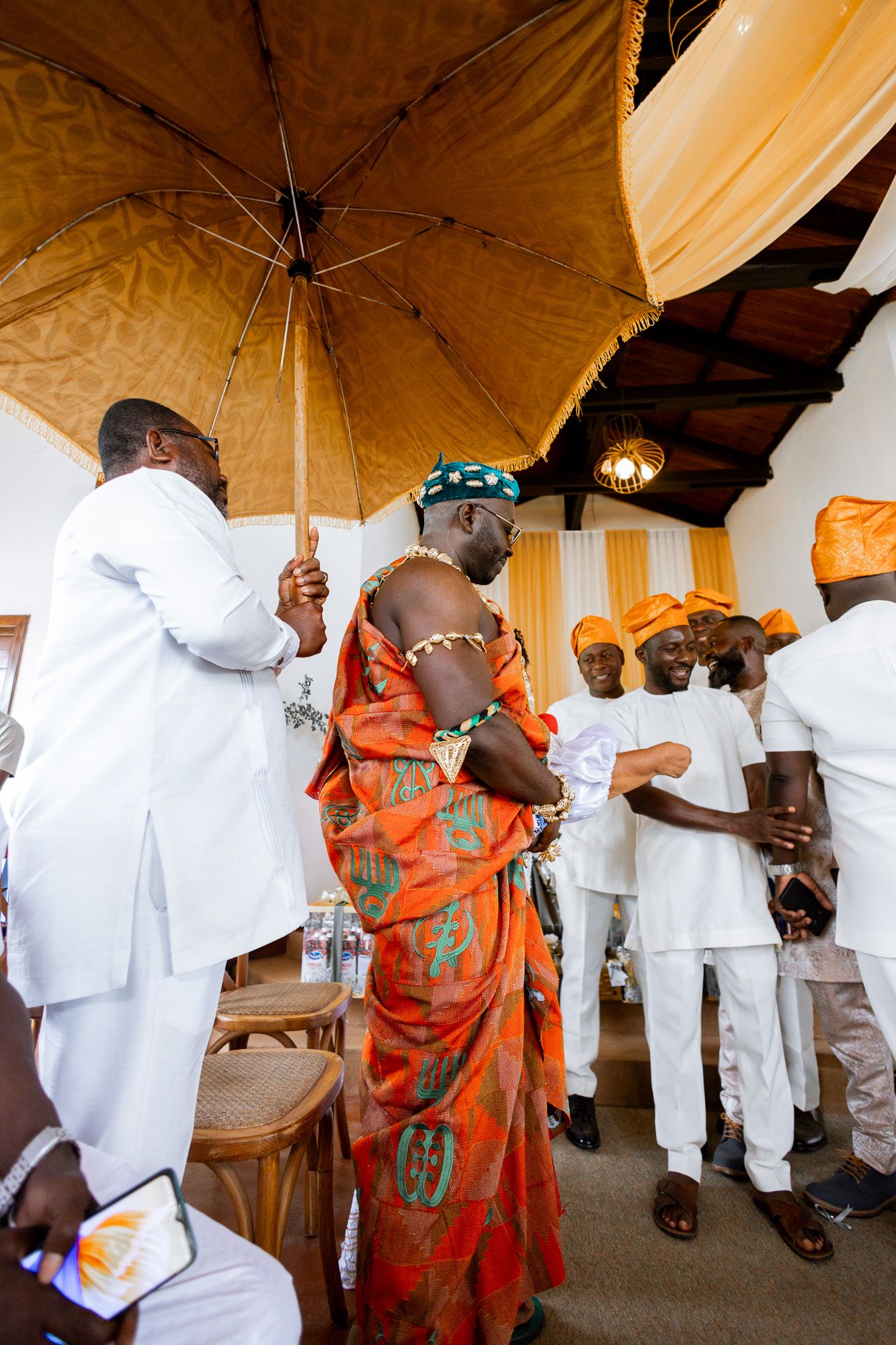 Groom making his entrance at wedding ceremony in Accra win kente