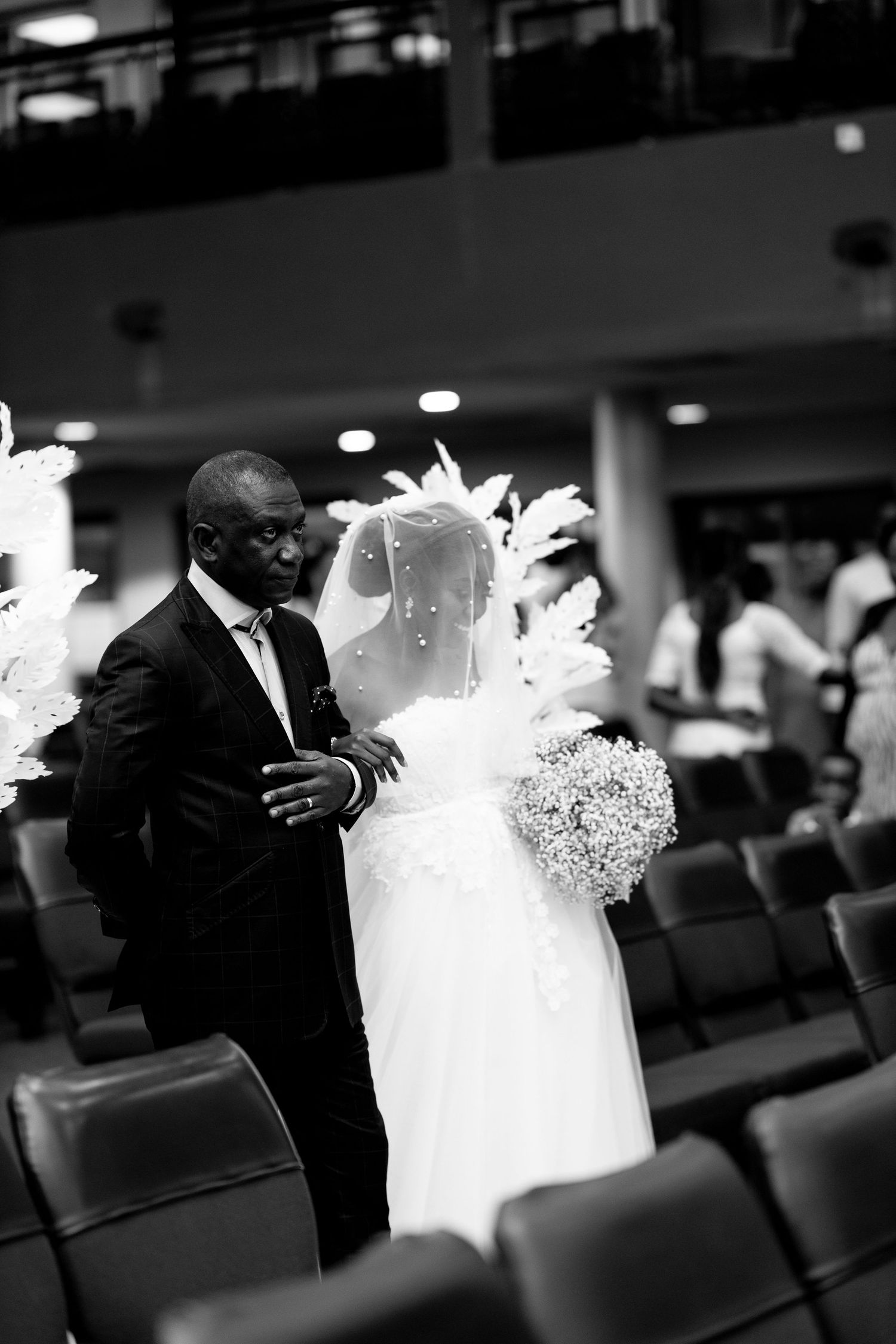 Bride walking down the aisle with her father at Ghana wedding