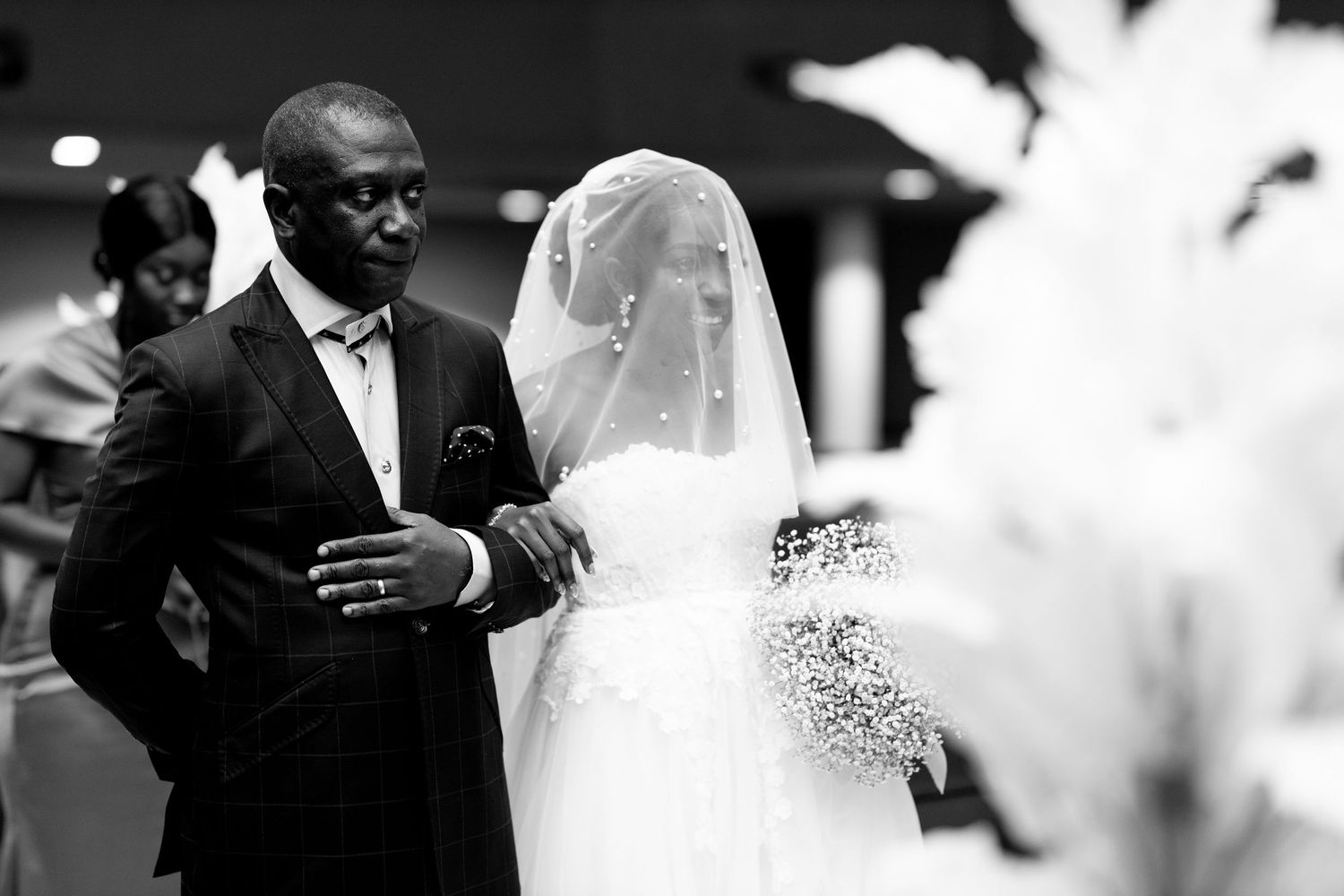 Bride walking down the aisle with her father at Ghana wedding
