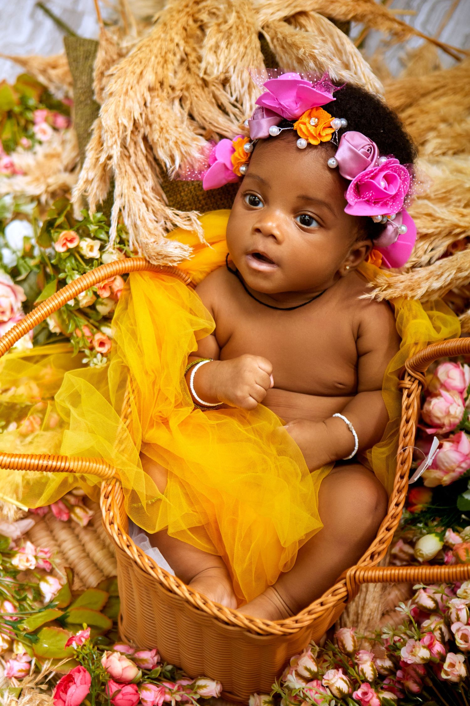 Baby Portrait with yellow flowers with warm tones