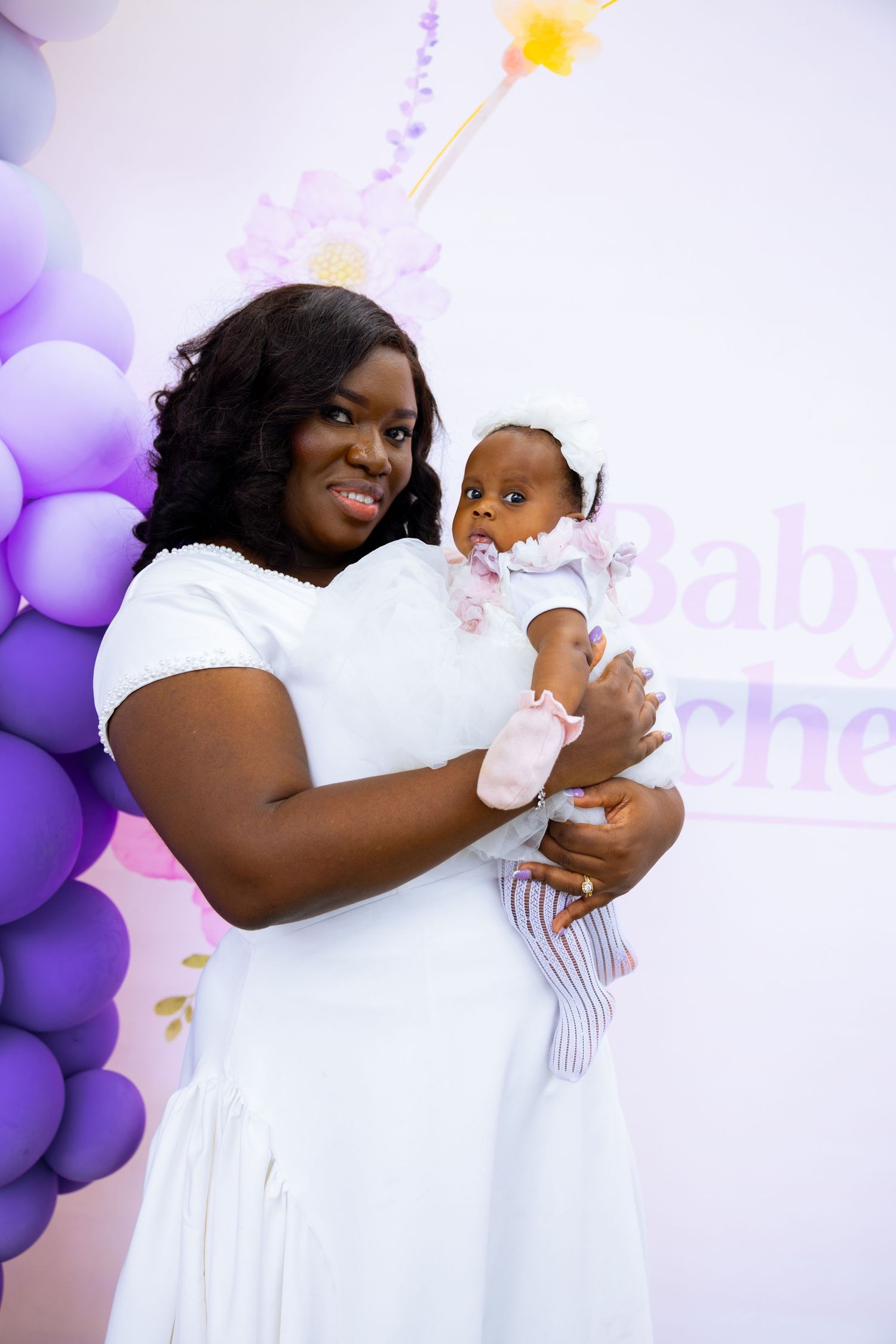 Baby surrounded by family at naming celebration reception