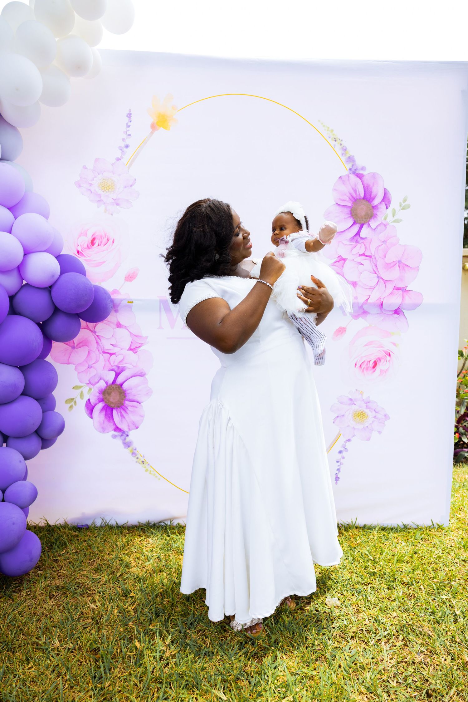 Baby surrounded by family at naming celebration reception