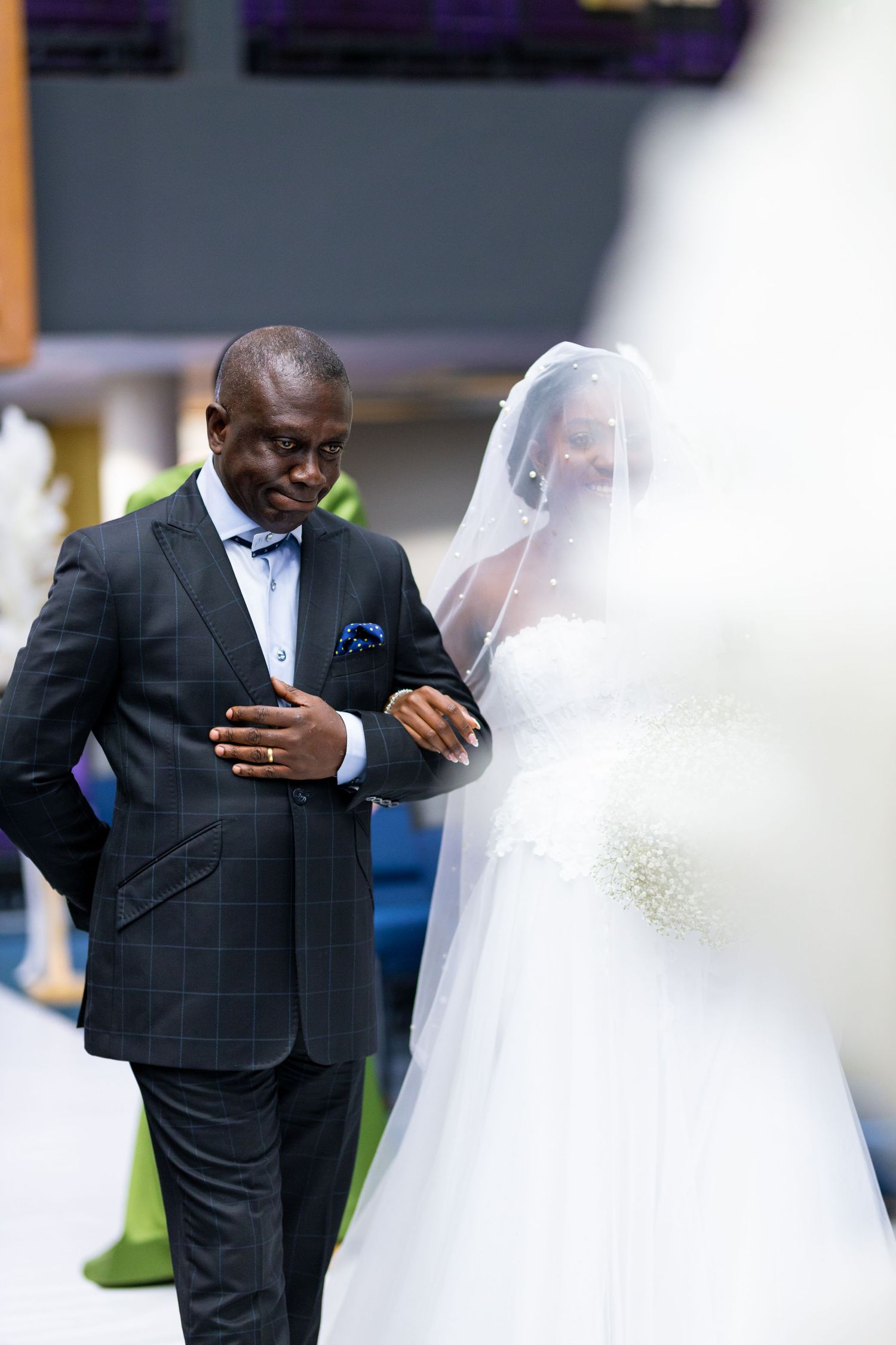 Bride walking down the aisle with her father at Ghana wedding