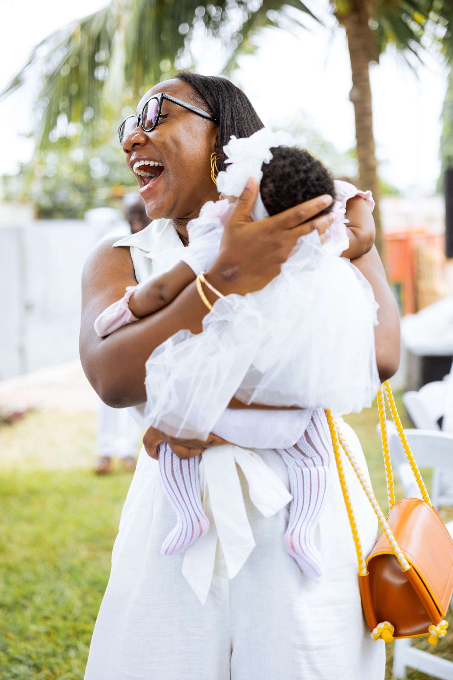 Baby surrounded by family at naming celebration reception