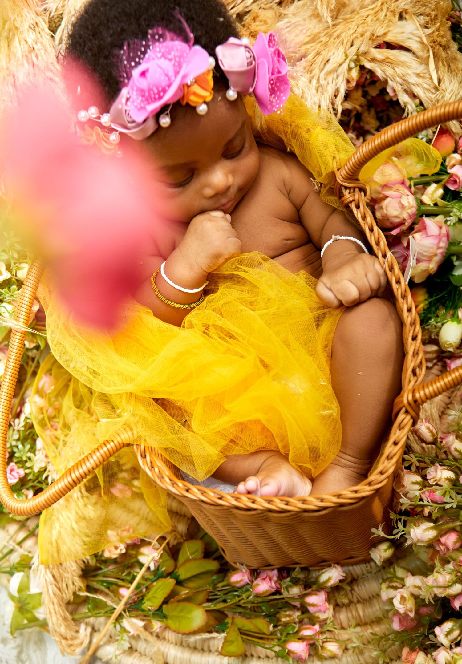 Baby Portrait with yellow flowers with warm tones