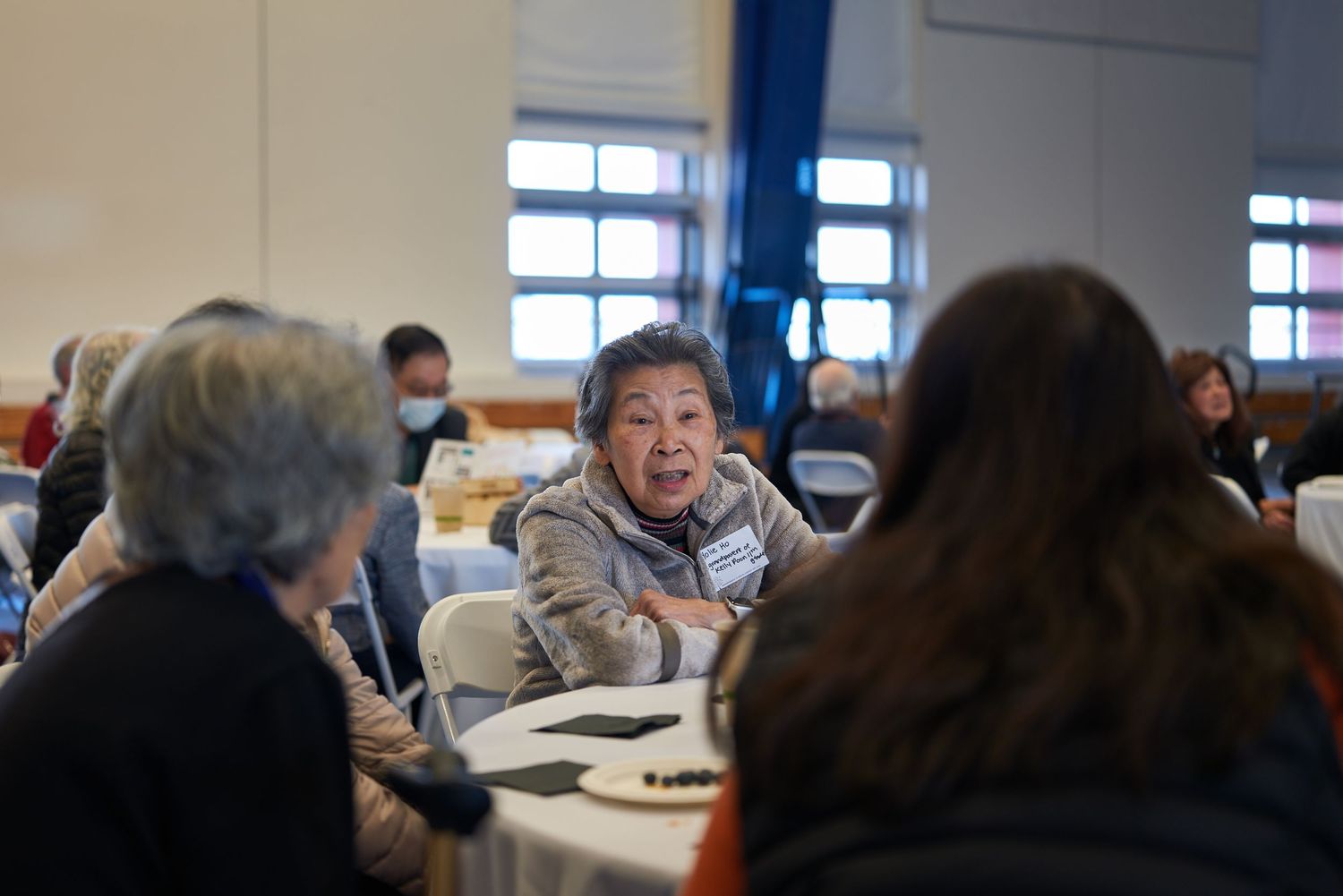 People engaged in lively discussion at community gathering table.