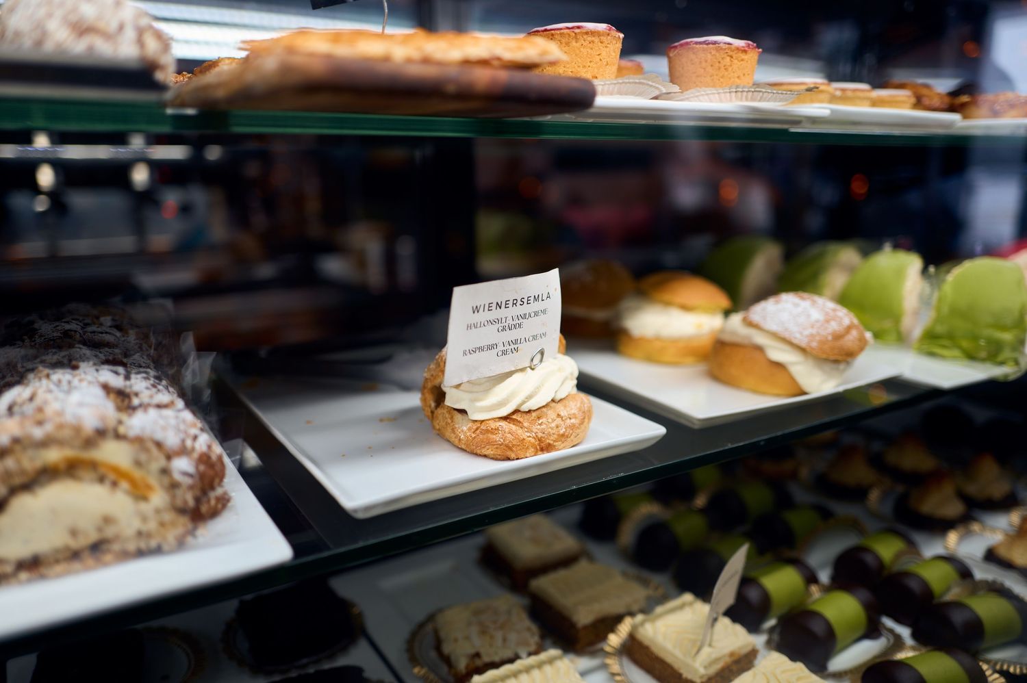 Display case of elegant pastries and desserts at a bakery counter.