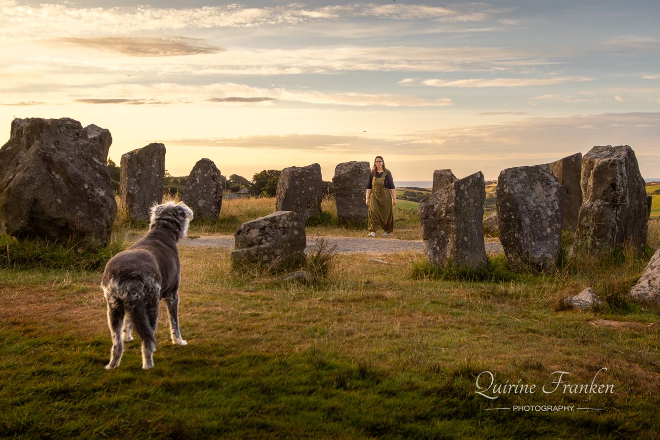 Dog looking at owner standing in Drombeg Stone Circle in West Cork