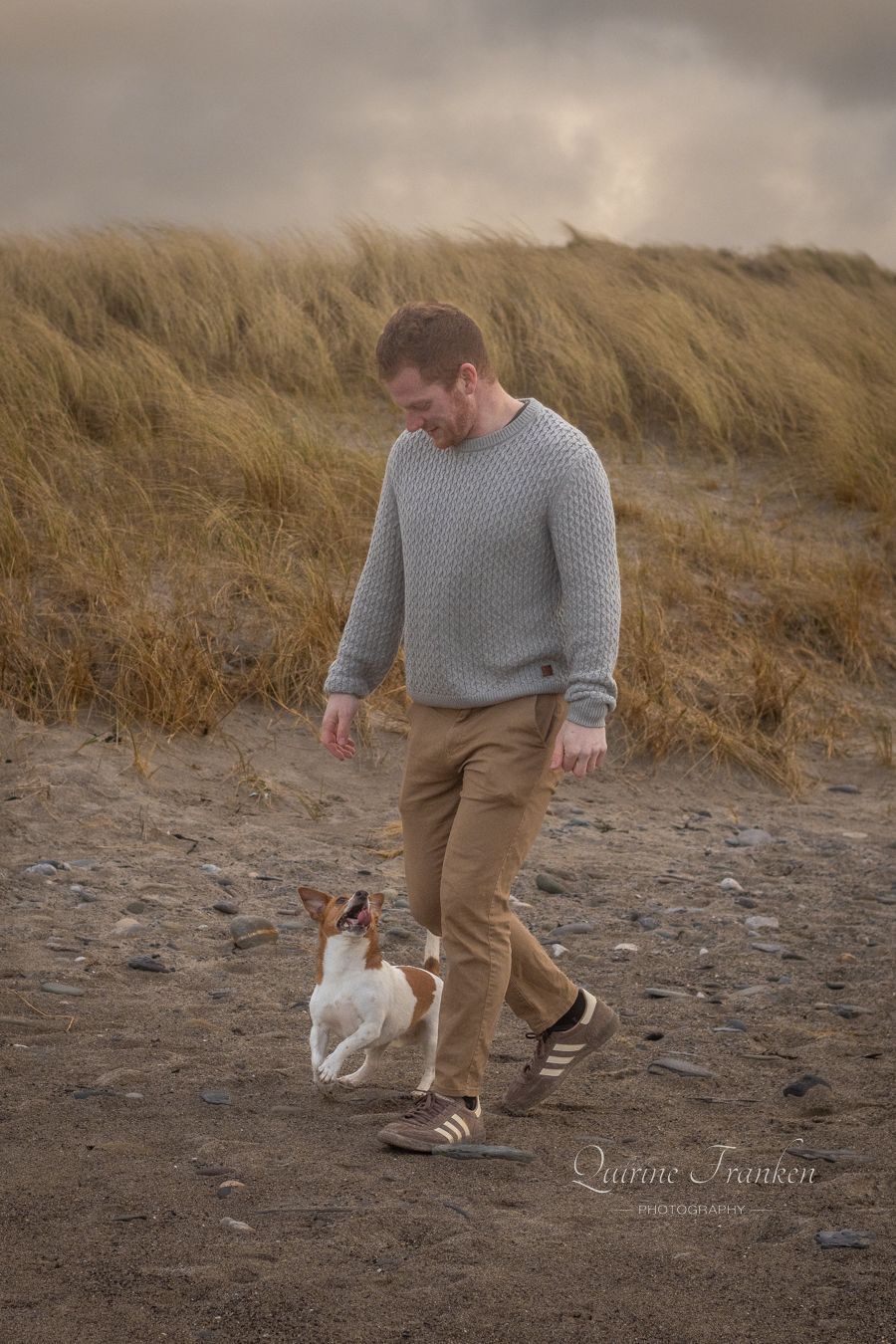 Dog and owner walking on the beach during a couple photoshoot with your dog in Cork