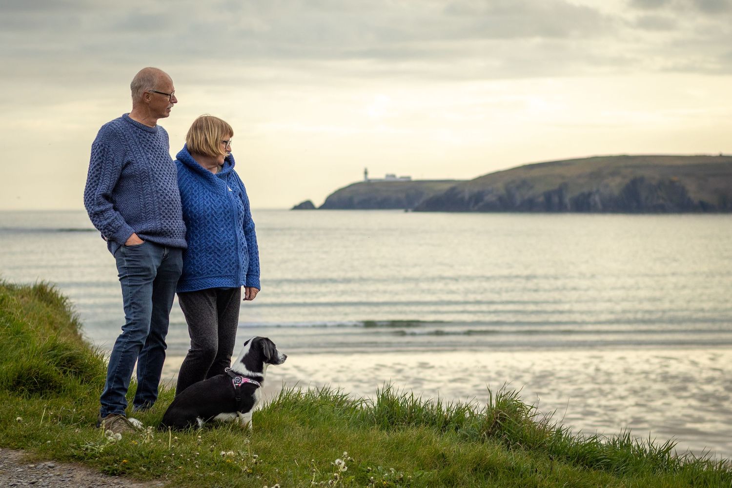 Couple and their dog at their holiday photshoot looking at Gally Head