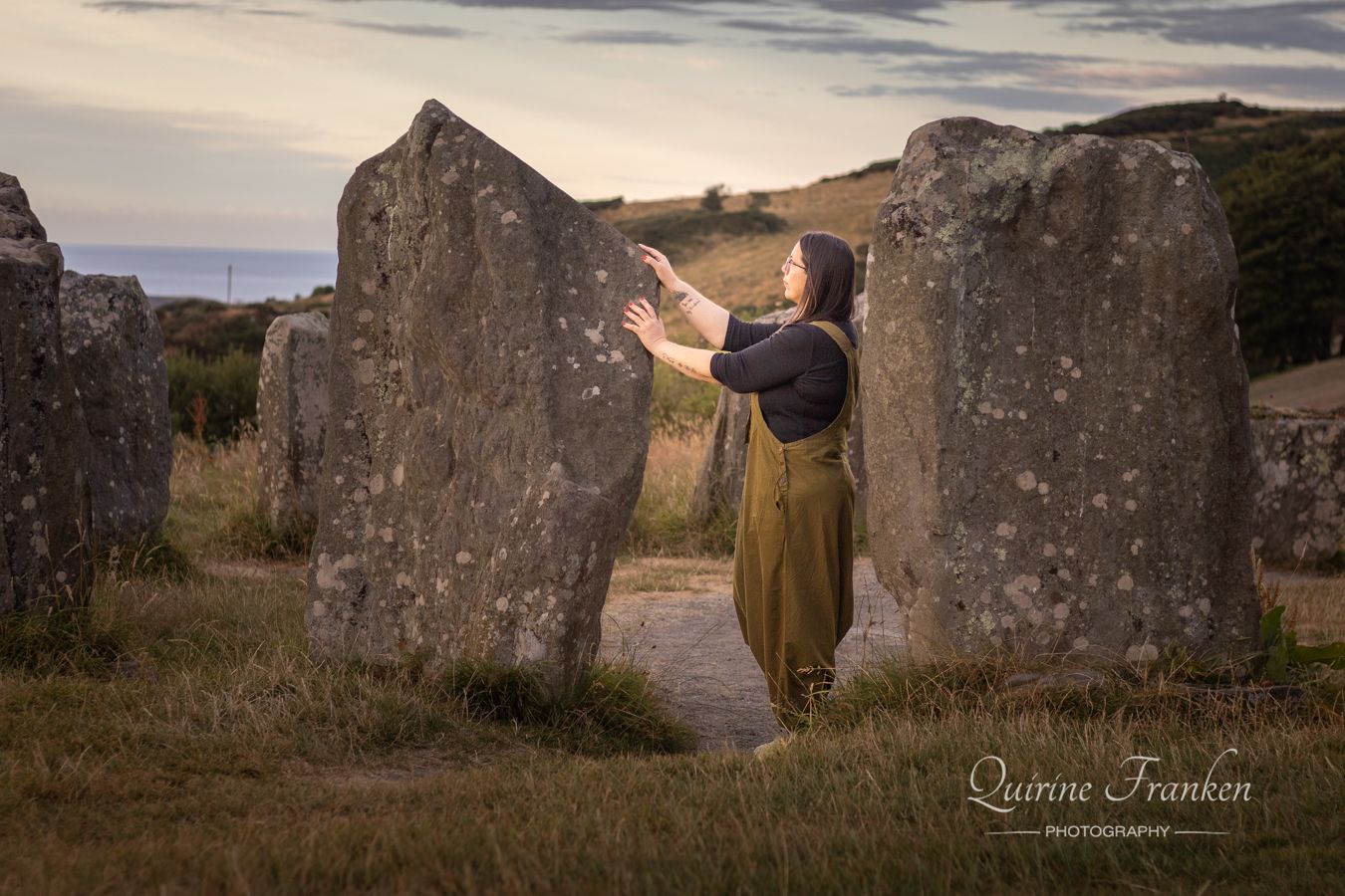 Women holding the stones at Drombeg Stone Circle in West Cork