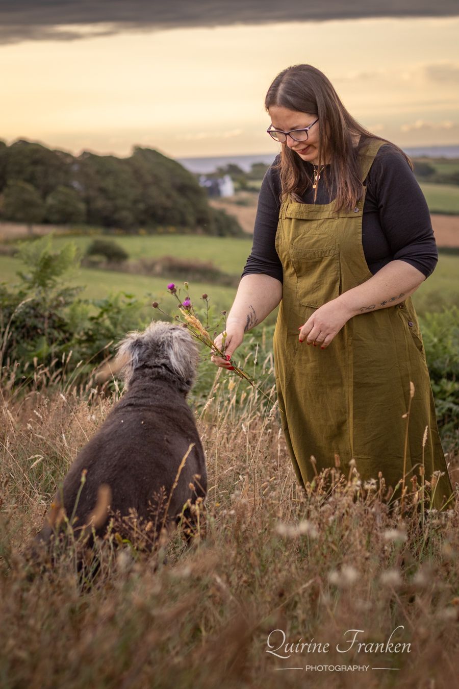 Dog and owner in tall grass during a photoshoot at Drombeg Stone Circle in West Cork