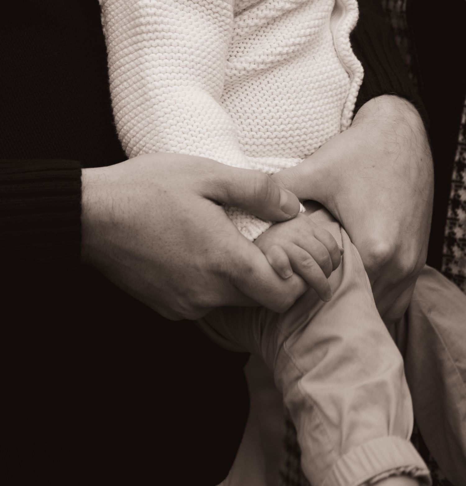 Close-up sequence of hands gently massaging and stretching a foot in a therapeutic setting.