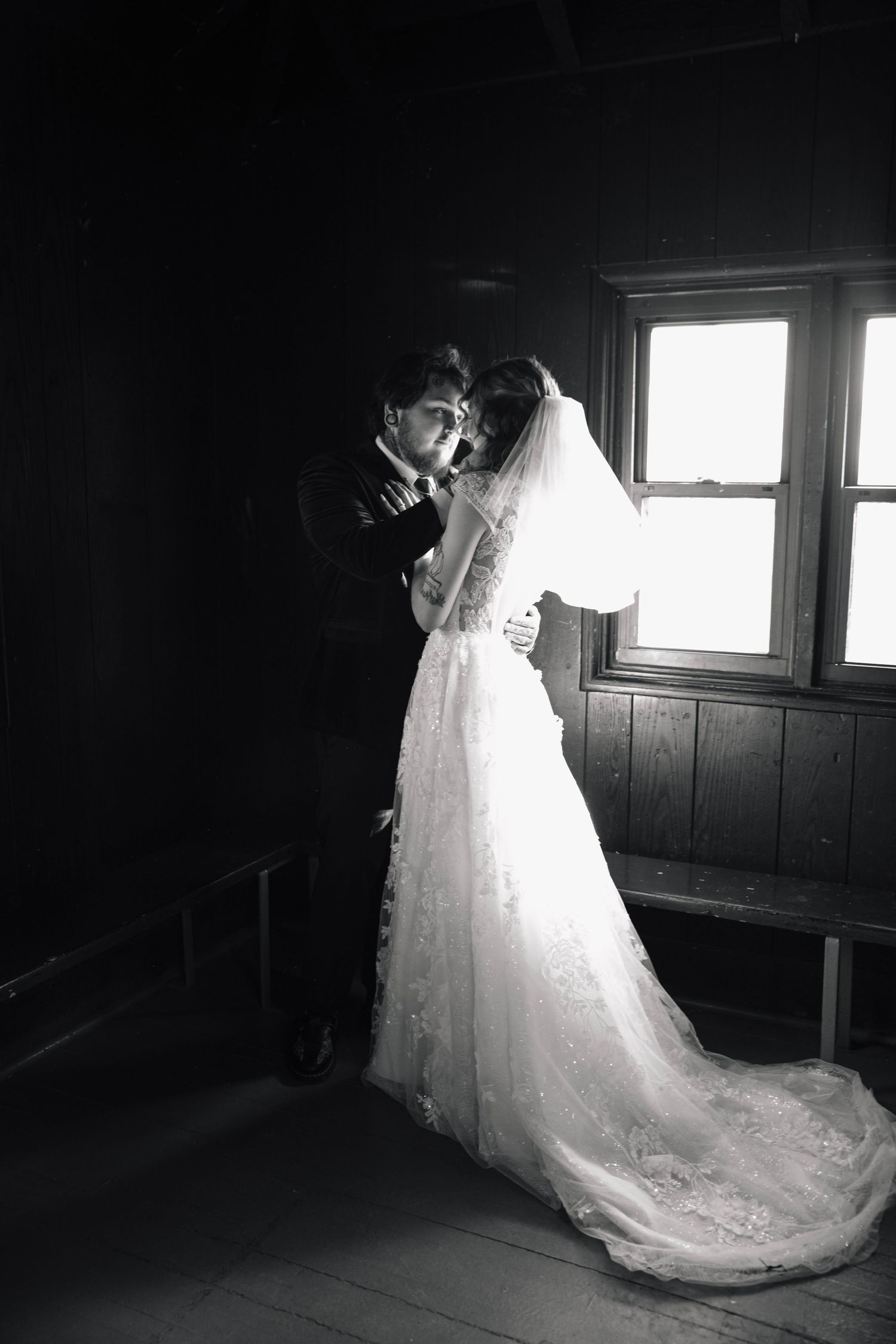 A series of black and white photos showing a wedding dress train flowing elegantly in a dark room.