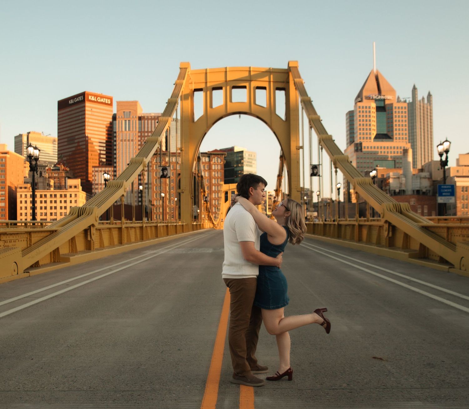 Romantic sunset photoshoot on Pittsburgh's iconic yellow Roberto Clemente Bridge.