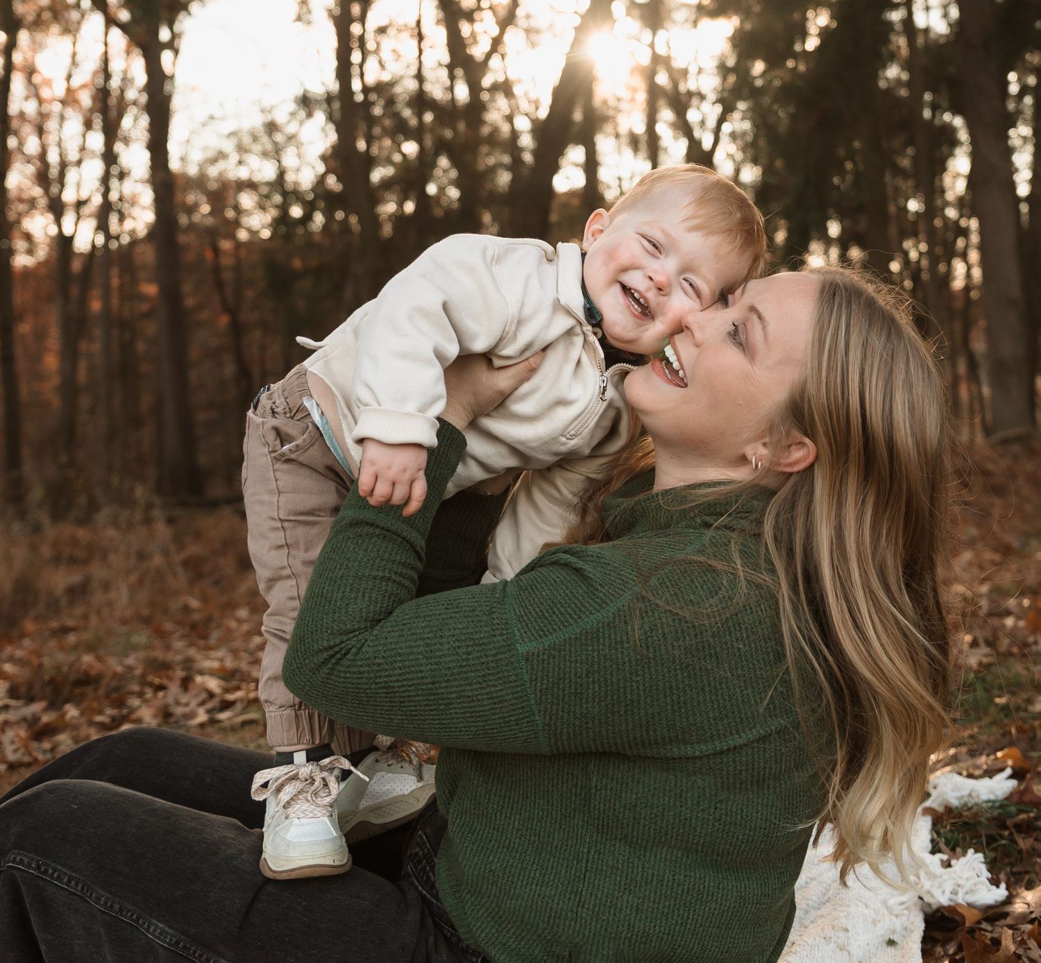 A tender moment captured in a series of playful interactions against an autumn forest backdrop.