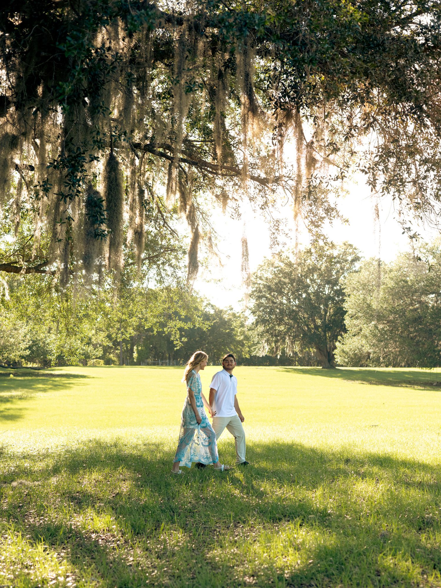Sunset field couples walking