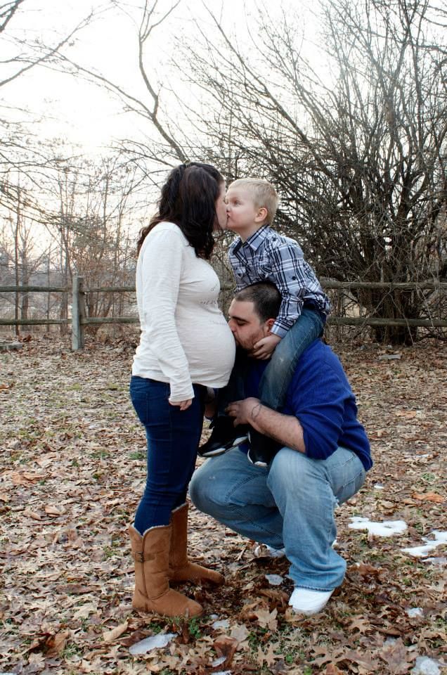A family poses together outdoors on a winter day.